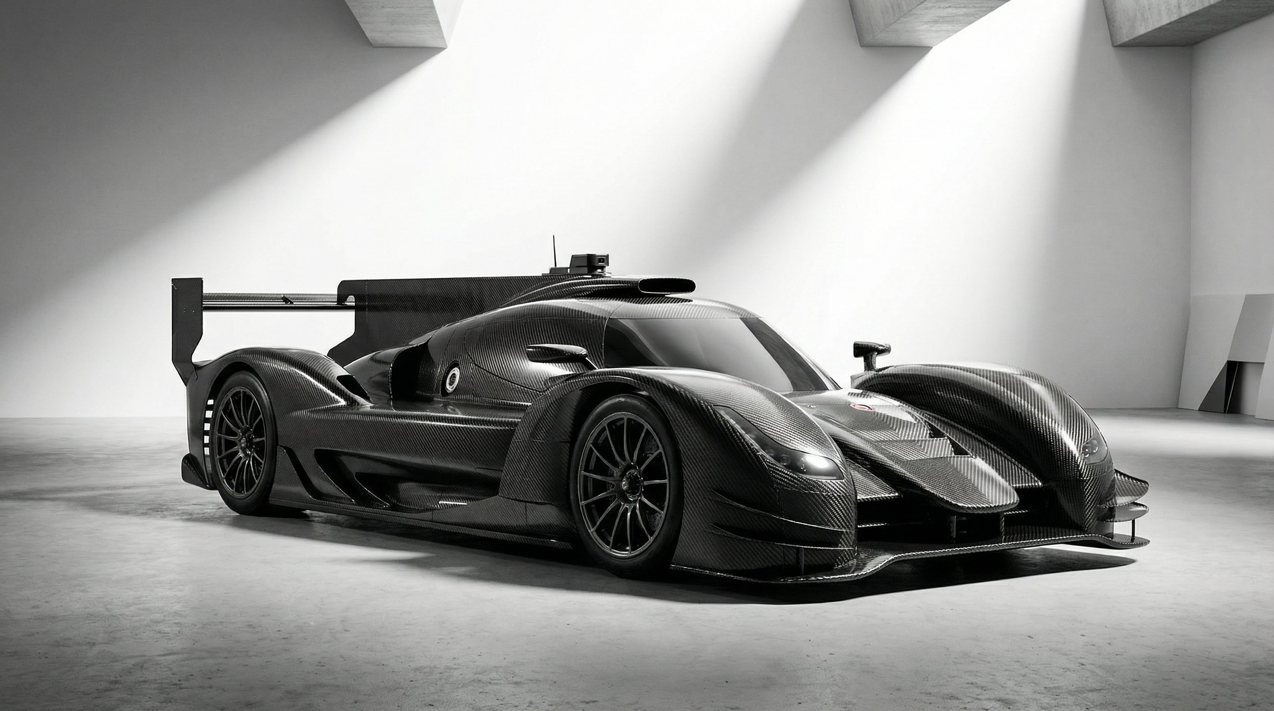 A sleek black race car with aerodynamic design and carbon fiber body in a minimalistic white room with angular architecture.