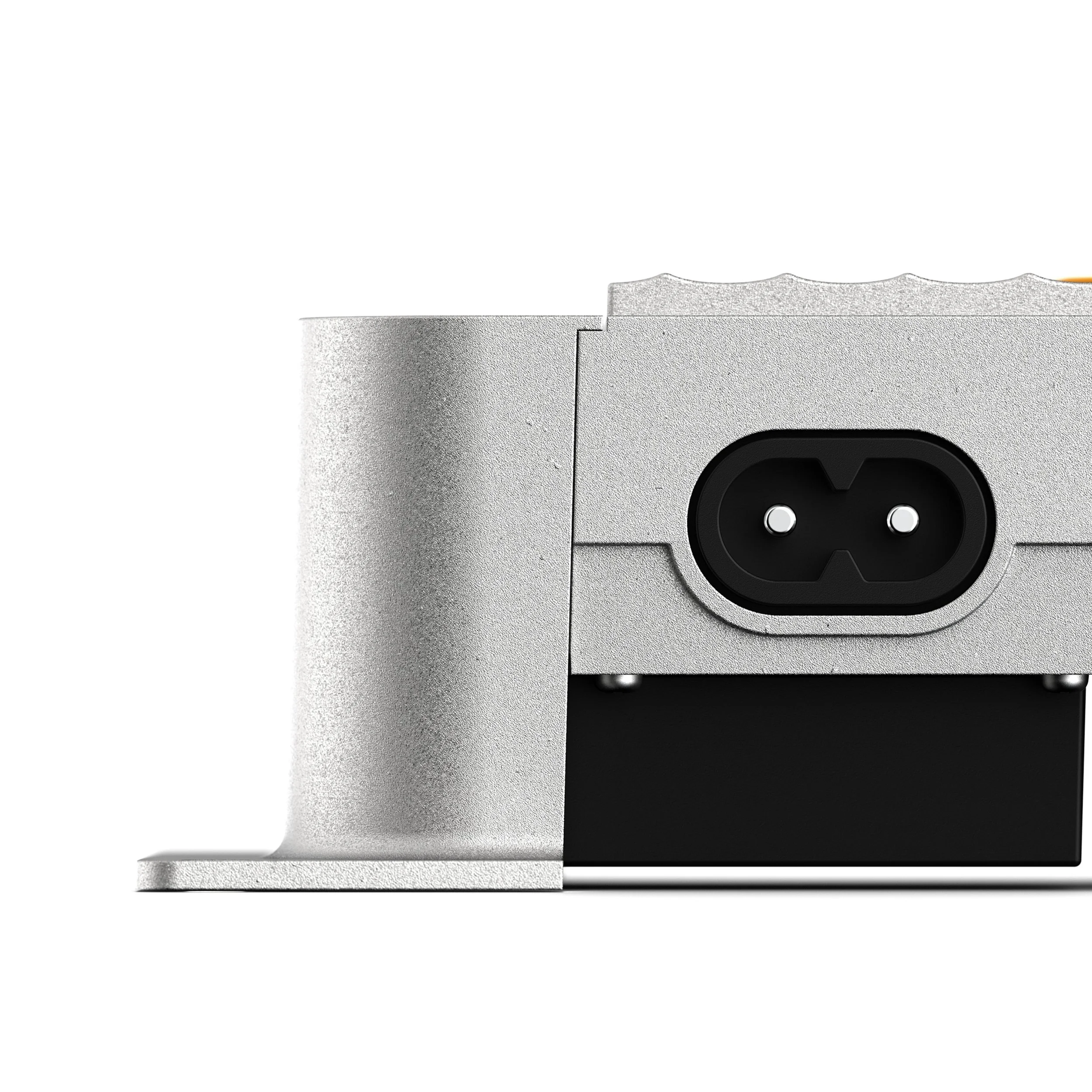 Close-up of a zinc electronic device with a black power input port.