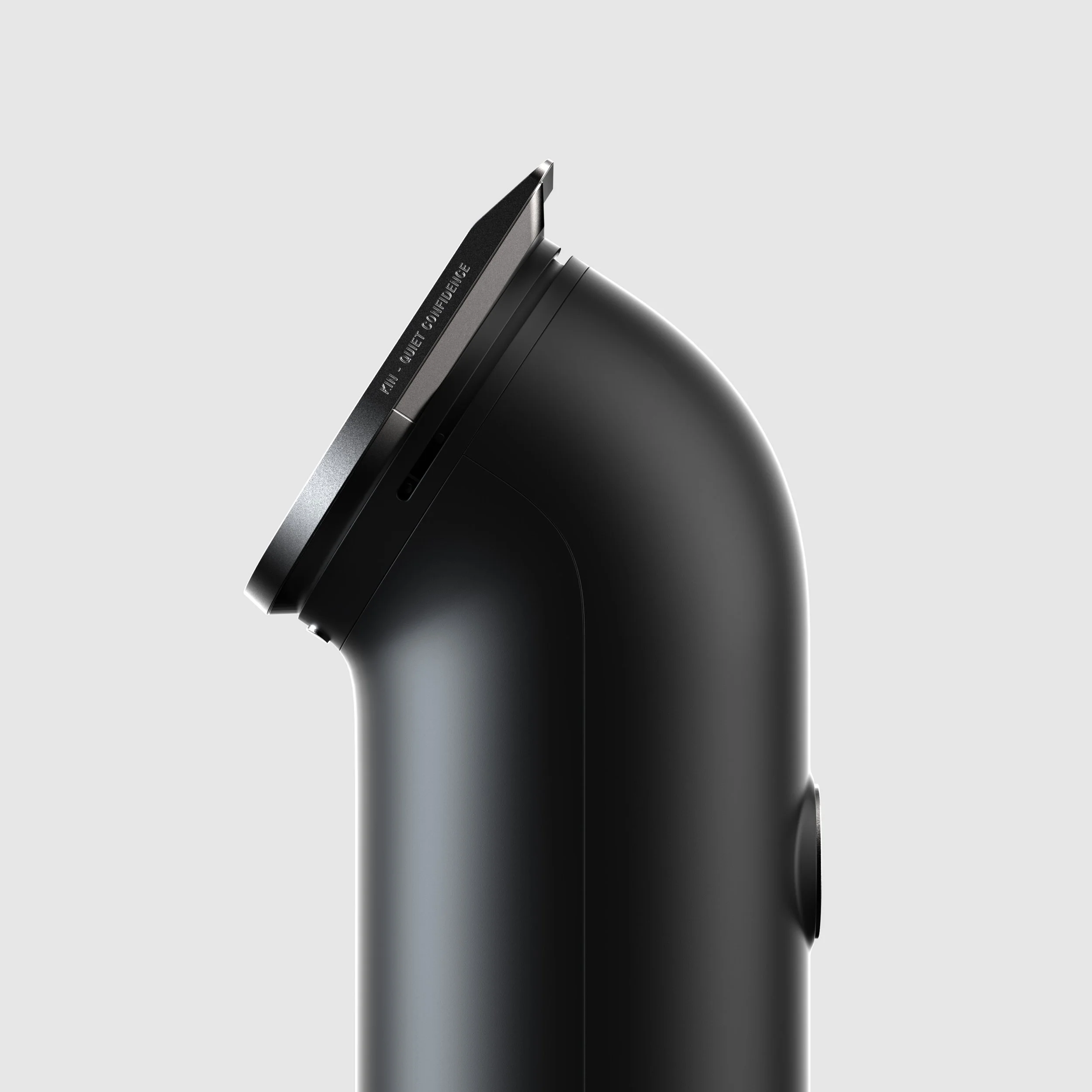 Close-up of a modern black gadget with a rounded design on a light gray background.