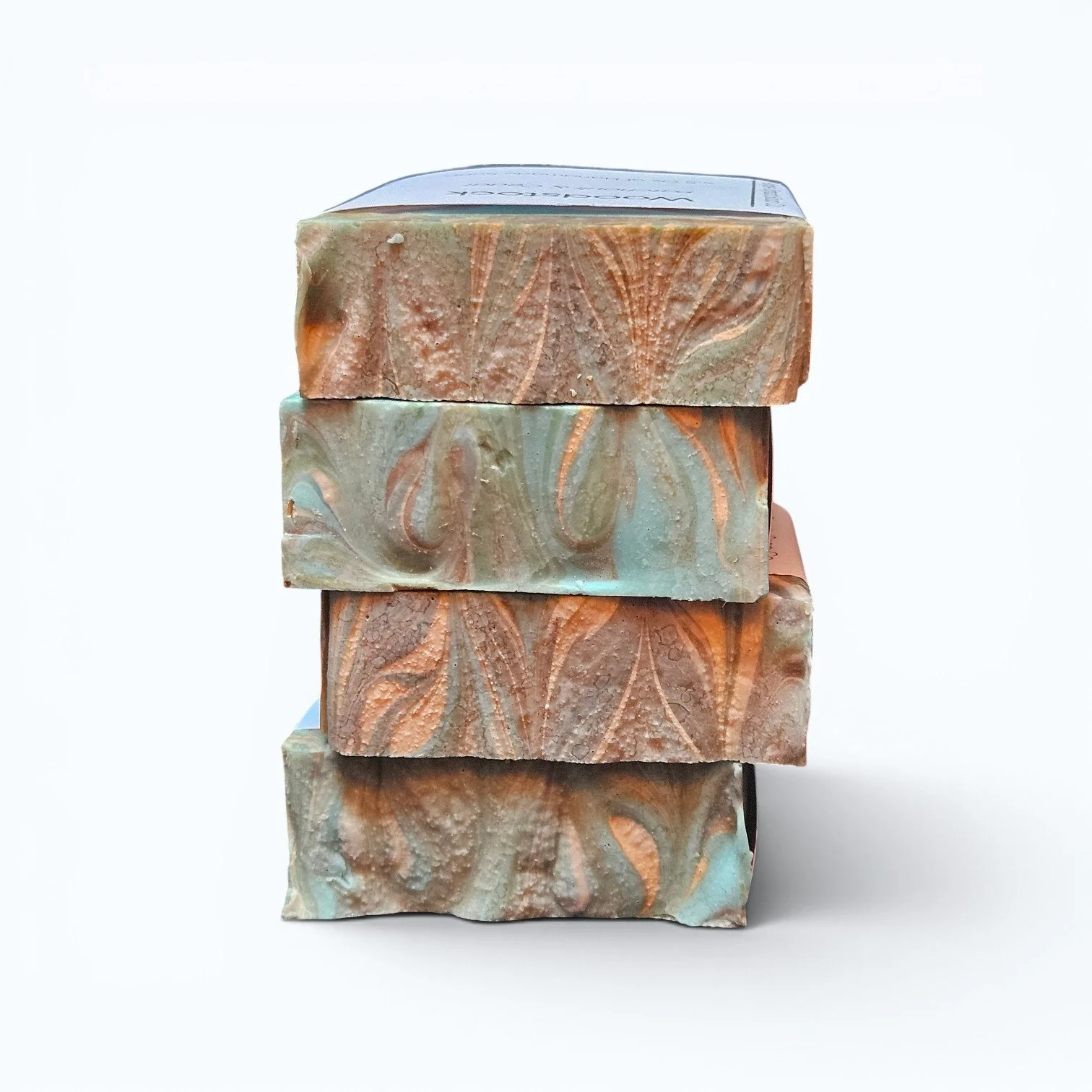 Stack of patchouli cedar soap bars showing natural cold process tops
