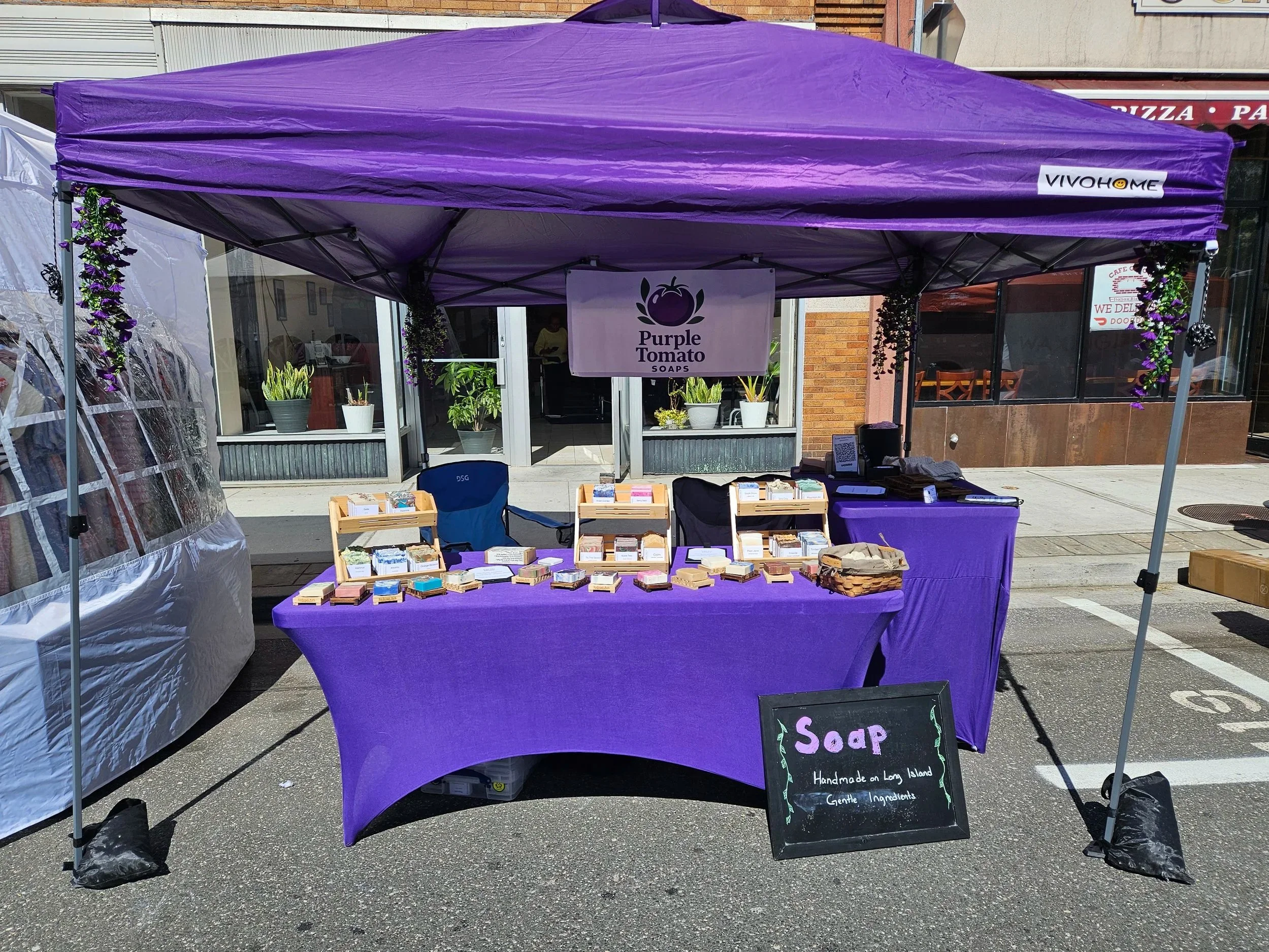 The Purple Tomato Soaps market booth from the Westbury Street Fair in May 2026.
