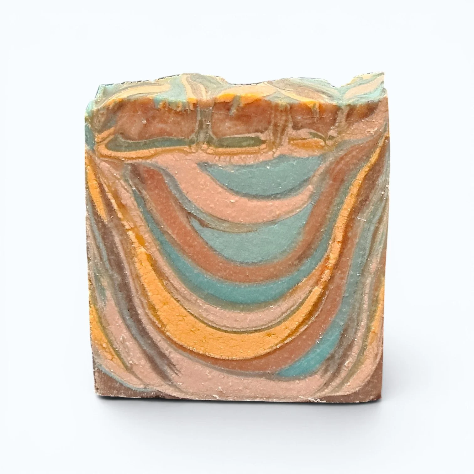 Close-up of handcrafted patchouli cedar soap bar showing natural cold process texture