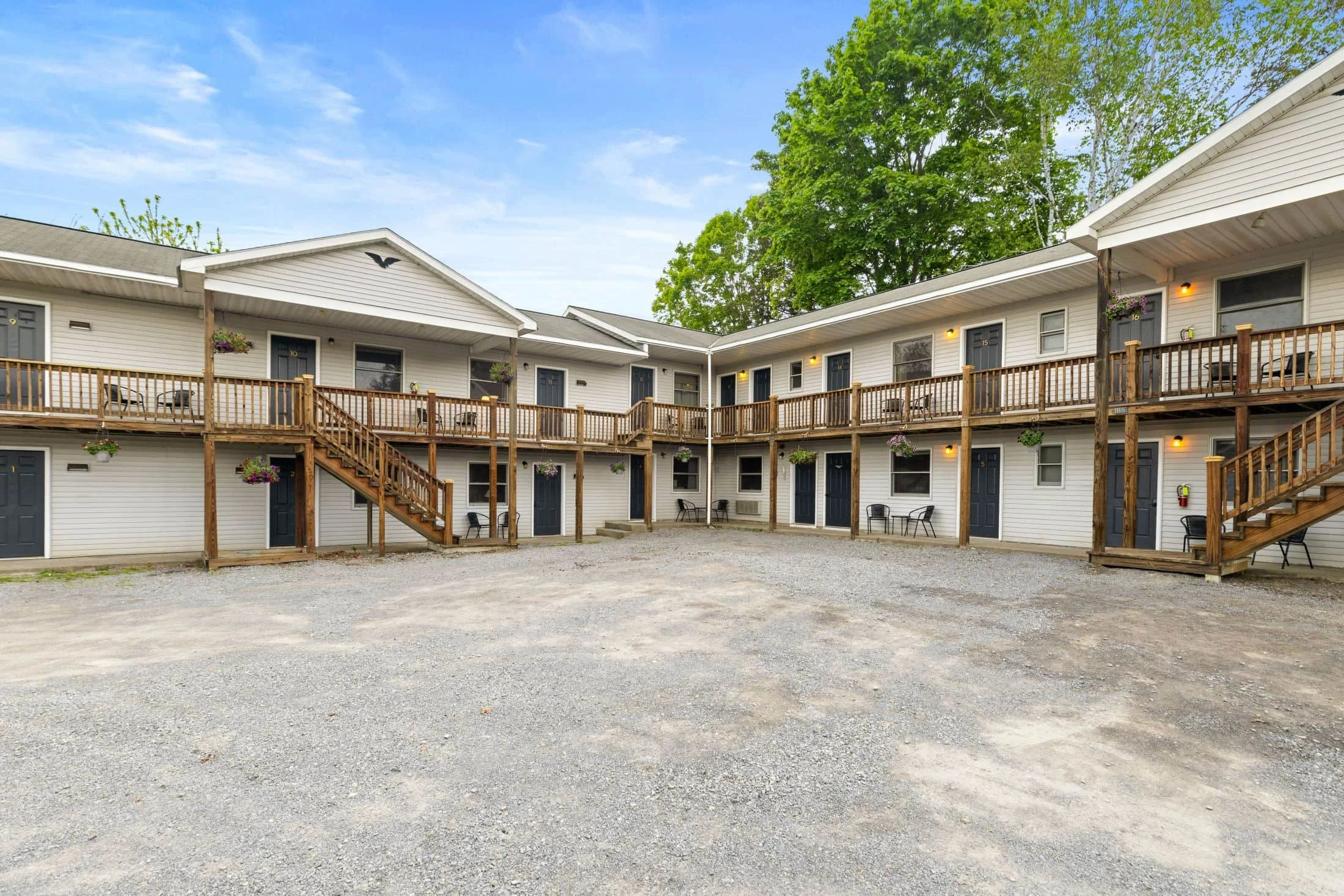 Exterior of KC’s Corner Motel with guest room entrances and parking near Cooperstown, NY