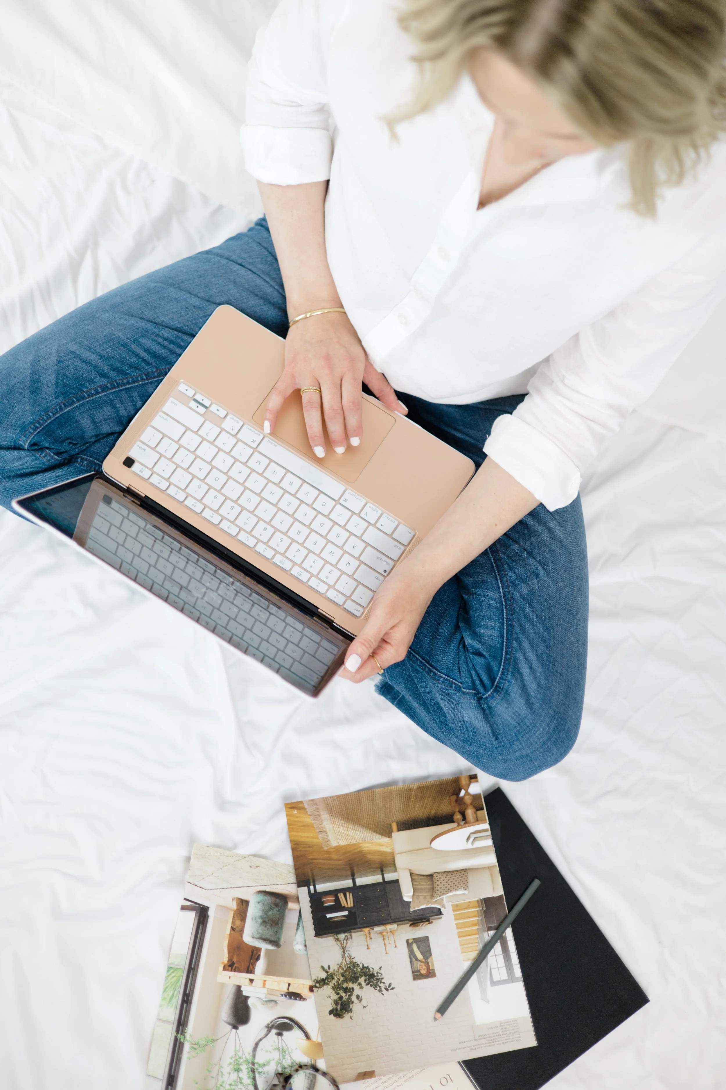 A overhead shot of Brittany Darr sitting on the floor with her Computer