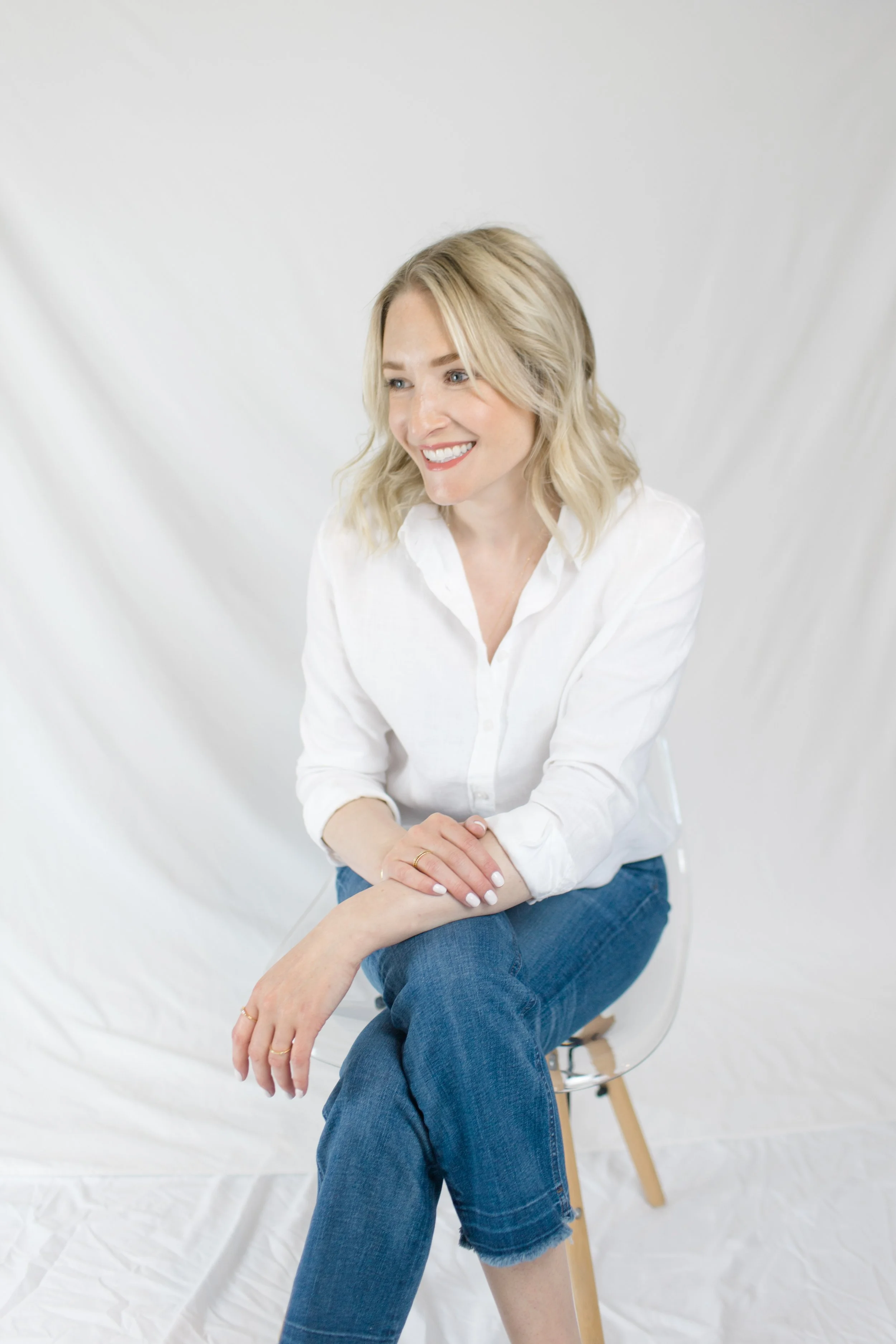 An image of Britt Darr wearing jeans and a white blouse.