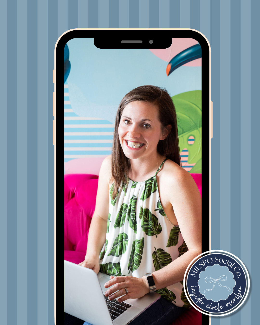 a photo of Alison bell sitting on a pink sofa and working on her laptop