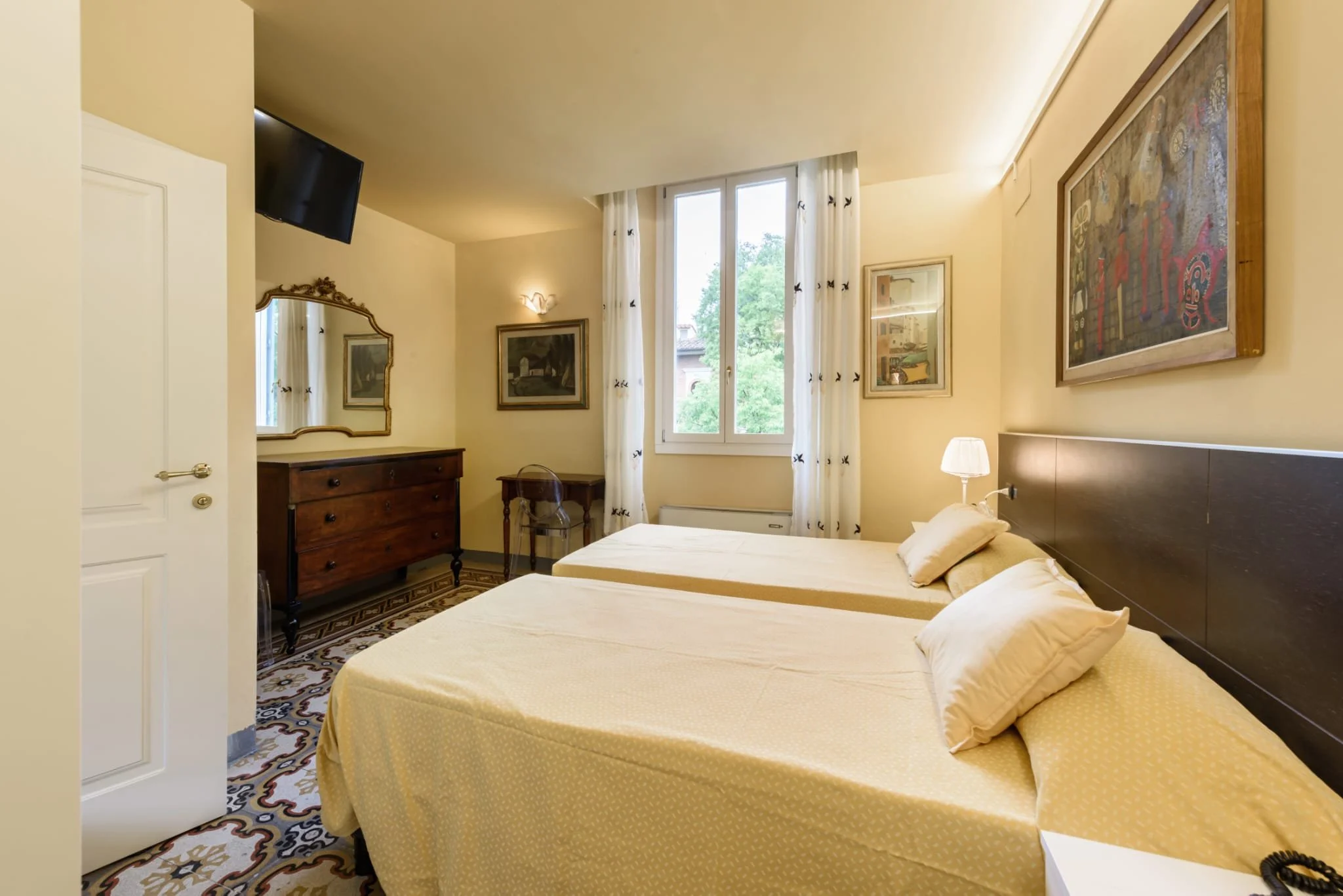 Yet another angle of the room with two single beds, this time showing the window.