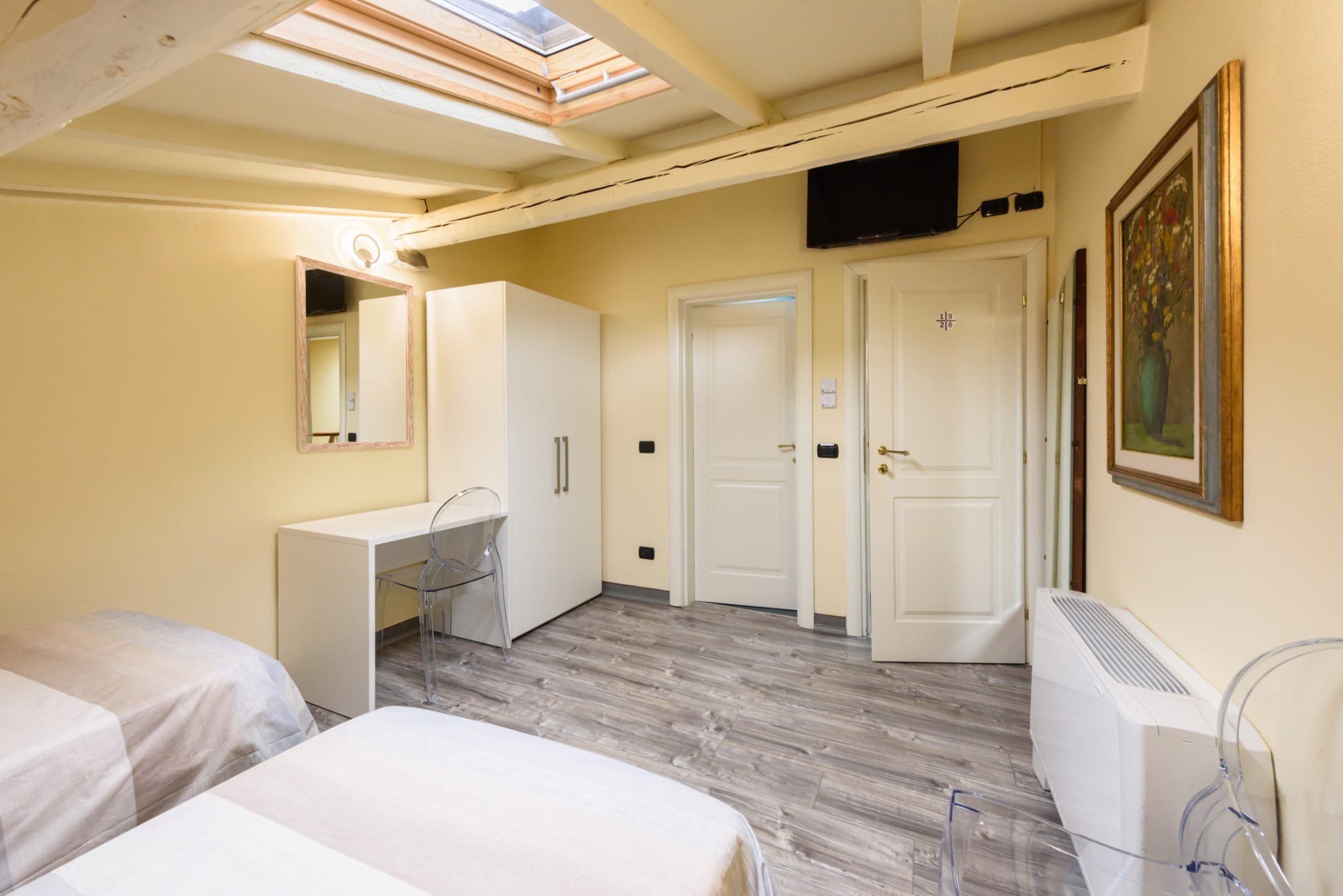 Image of a room with two double beds taken from yet another angle (showing the entrance door and toilet door)