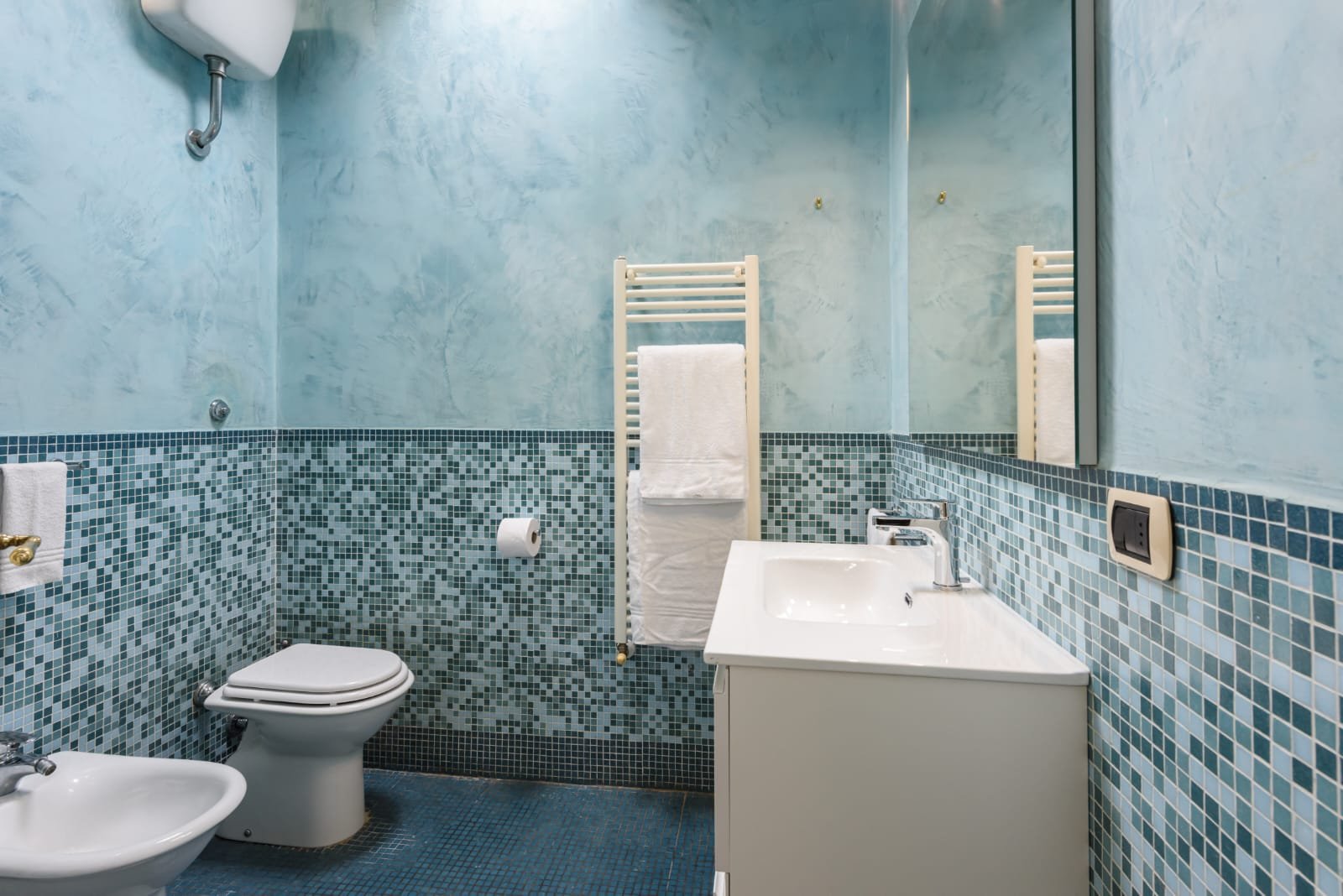 another image of the light blue tiled toilet but from a different angle