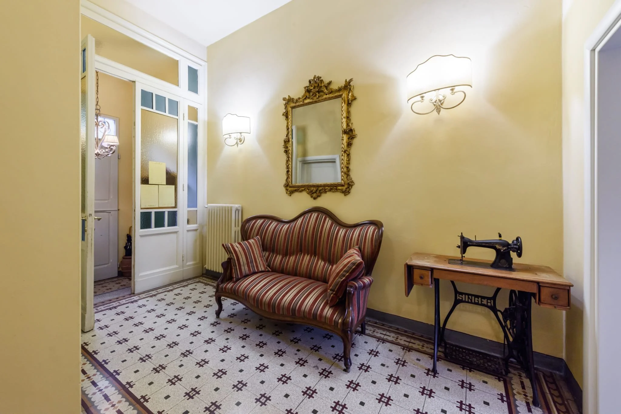 Image of the lobby with chair and old sewing machine