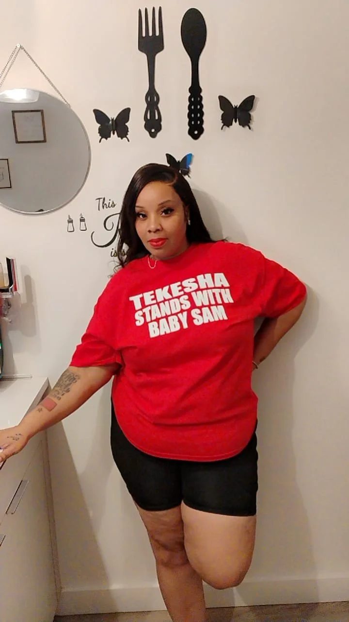 Tekesha wearing STAND WITH BABY SAM t-shirt
