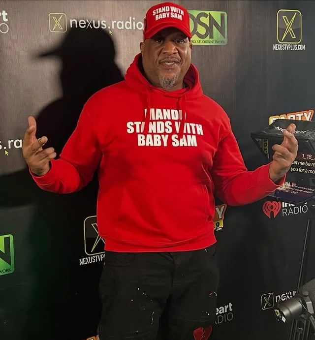Mandu wearing STAND WITH BABY SAM hoodie and hat