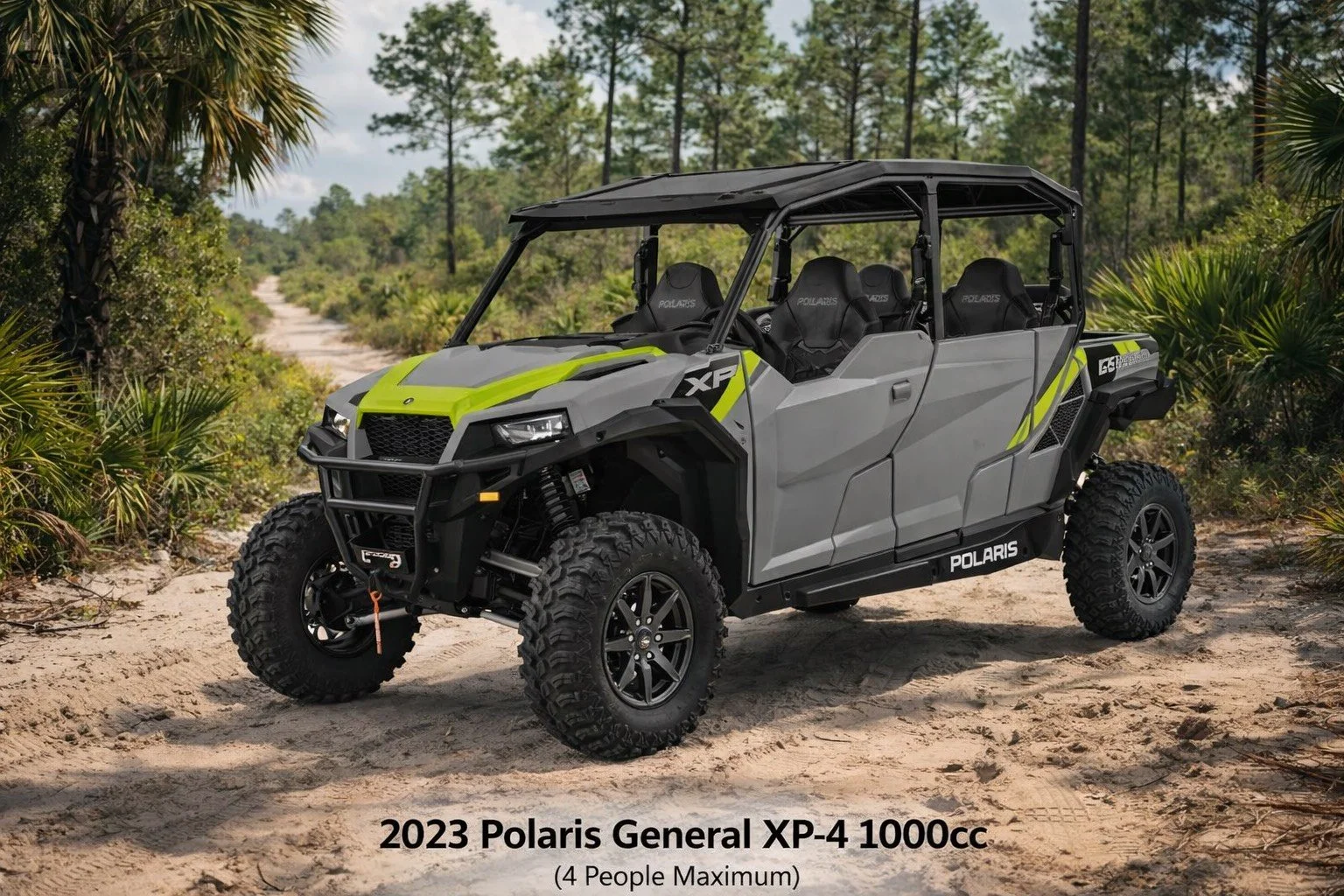 2023 Polaris General XP-4 1000cc off-road utility vehicle on sandy trail with trees and bushes in background, four seats, rugged tires, black roll cage, electric winch at front, black accents, and green and grey bodywork.