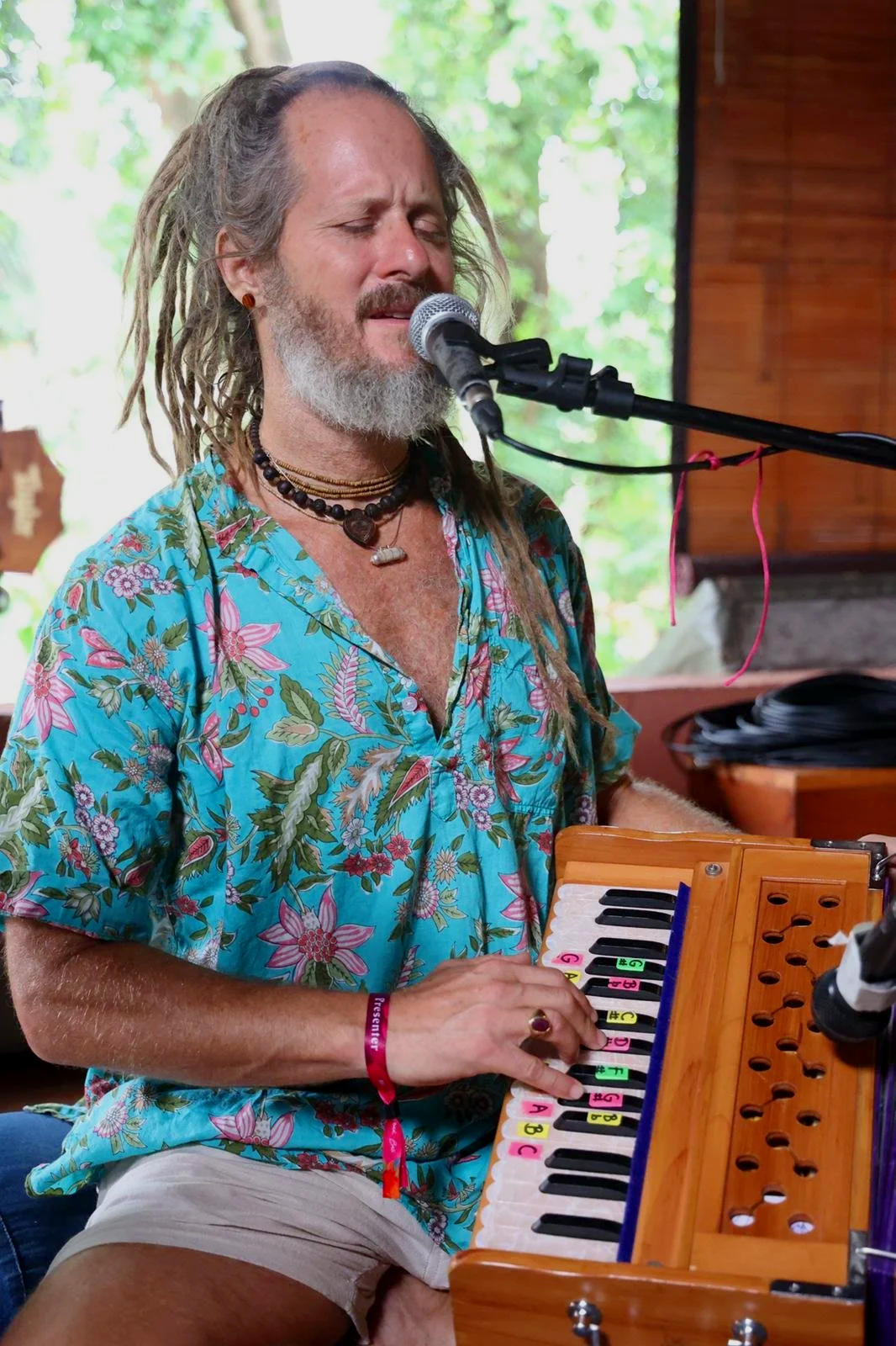 Kirtan musician Govind Das singing and playing harmonium during a devotional music gathering