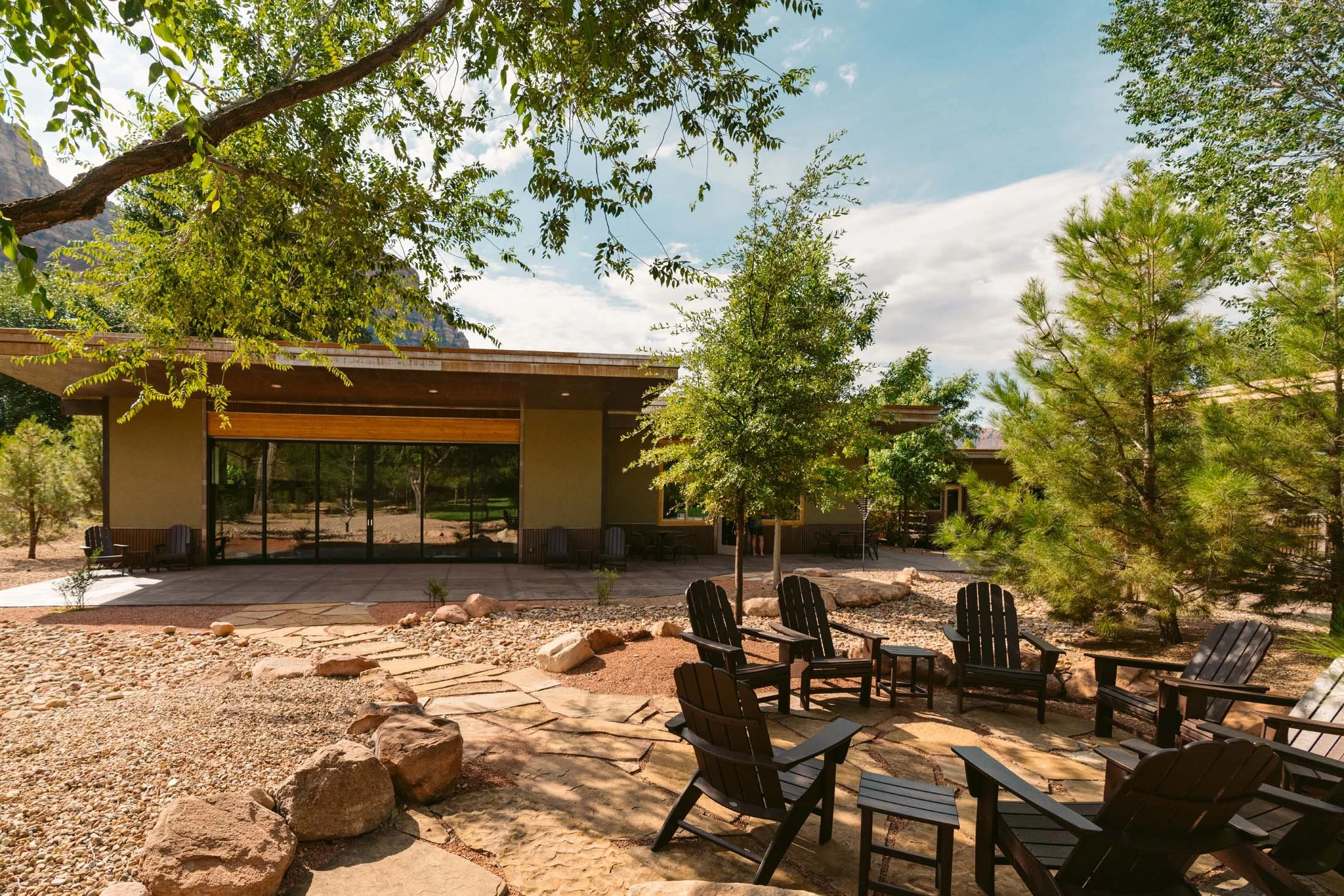 Nama-Stay Pavilion and outdoor gathering circle surrounded by mature trees and red rock landscaping near Zion National Park.