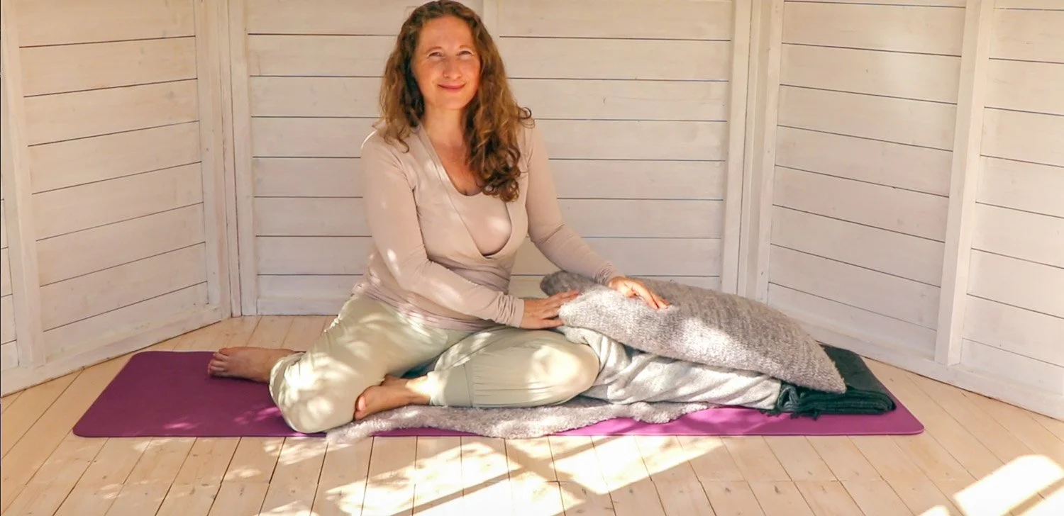 En kvinne gjør restituerende yoga som kveldsyoga