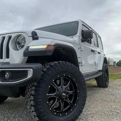Lifted Jeep Wrangler with off road wheels and tires and window tint. 