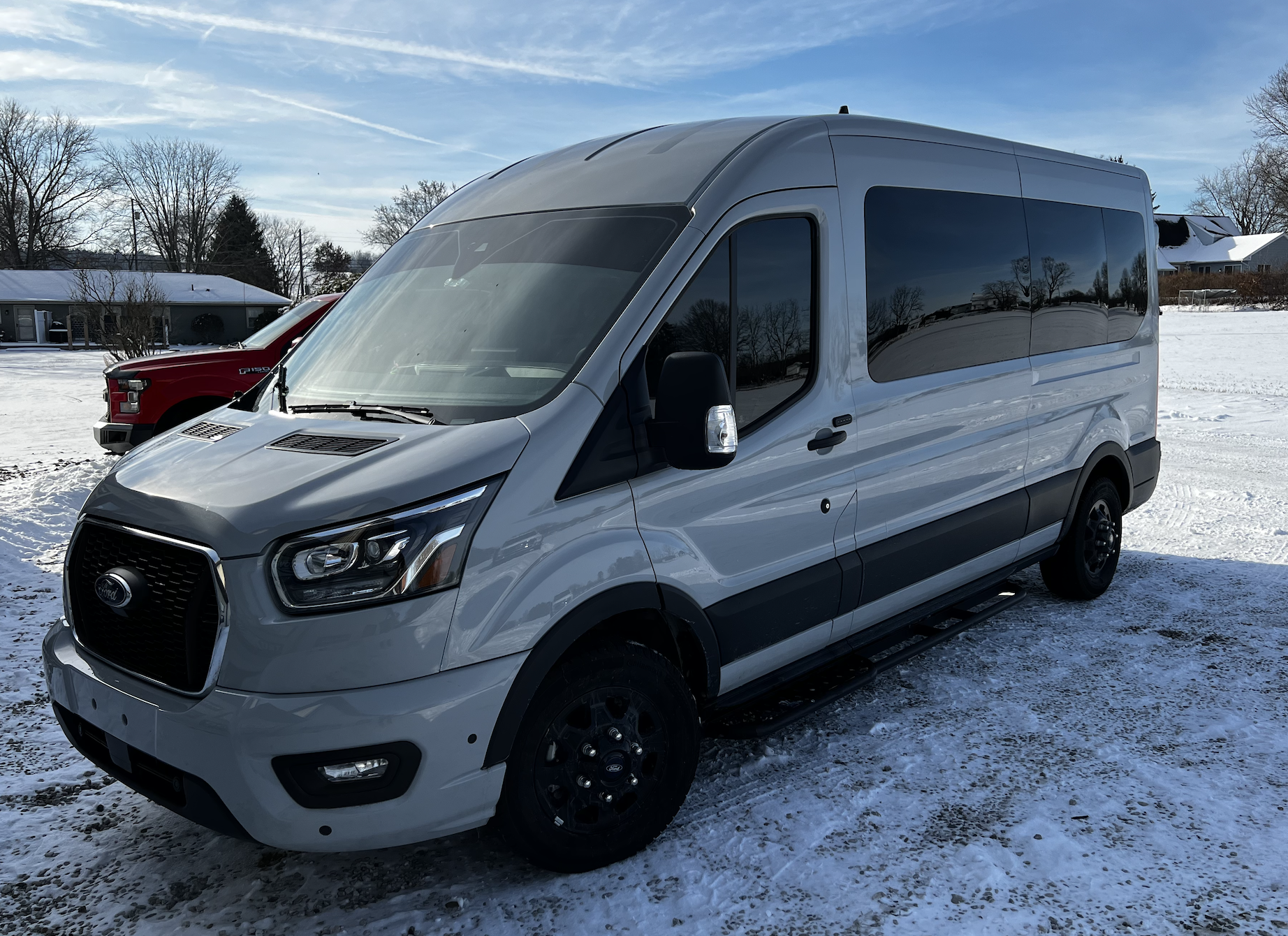 Custom tinted Ford Transit van with all of the windows and the windshield tinted. Fitted with custom length running boards. 