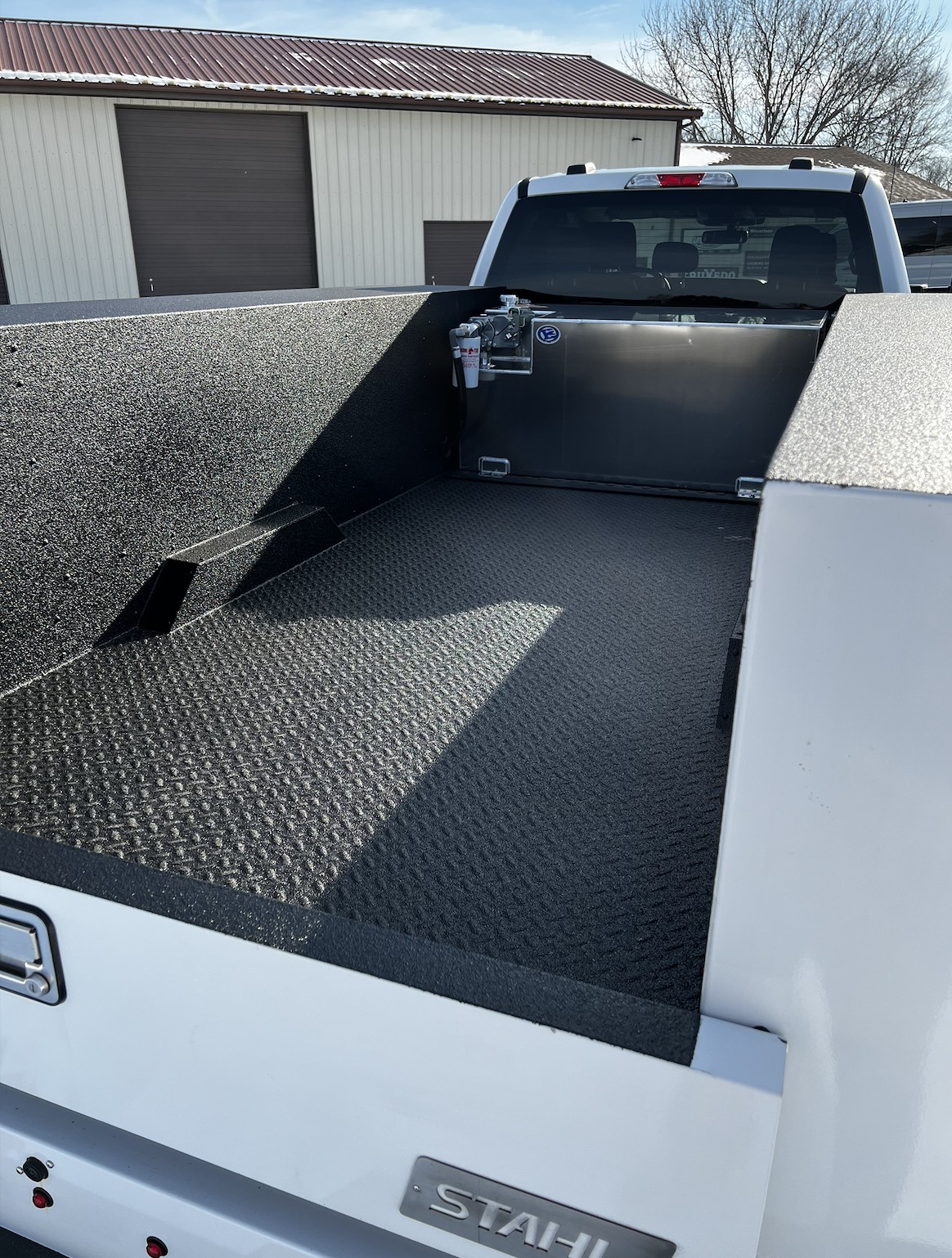 Custom spray-in bedliner on a utility bed for a work truck. 