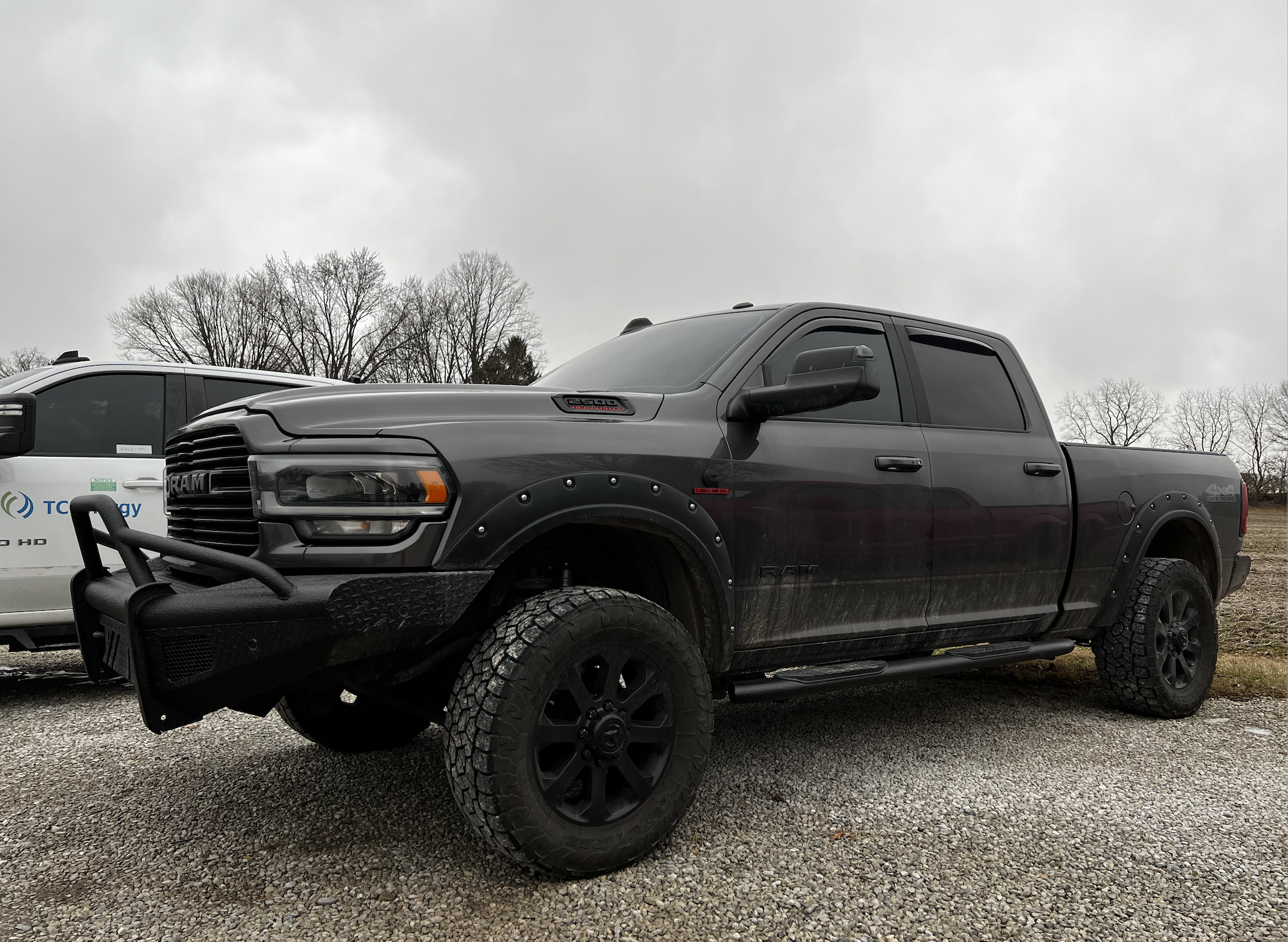 Dodge Ram with tinted windows and windshield. Lift kit with off-road wheels and tires and upgraded front bumper. 