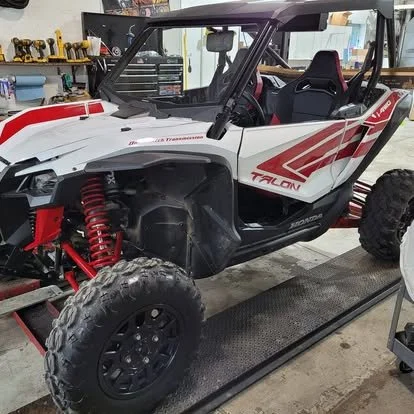 Side-by-side with custom graphics and off-road lighting. 