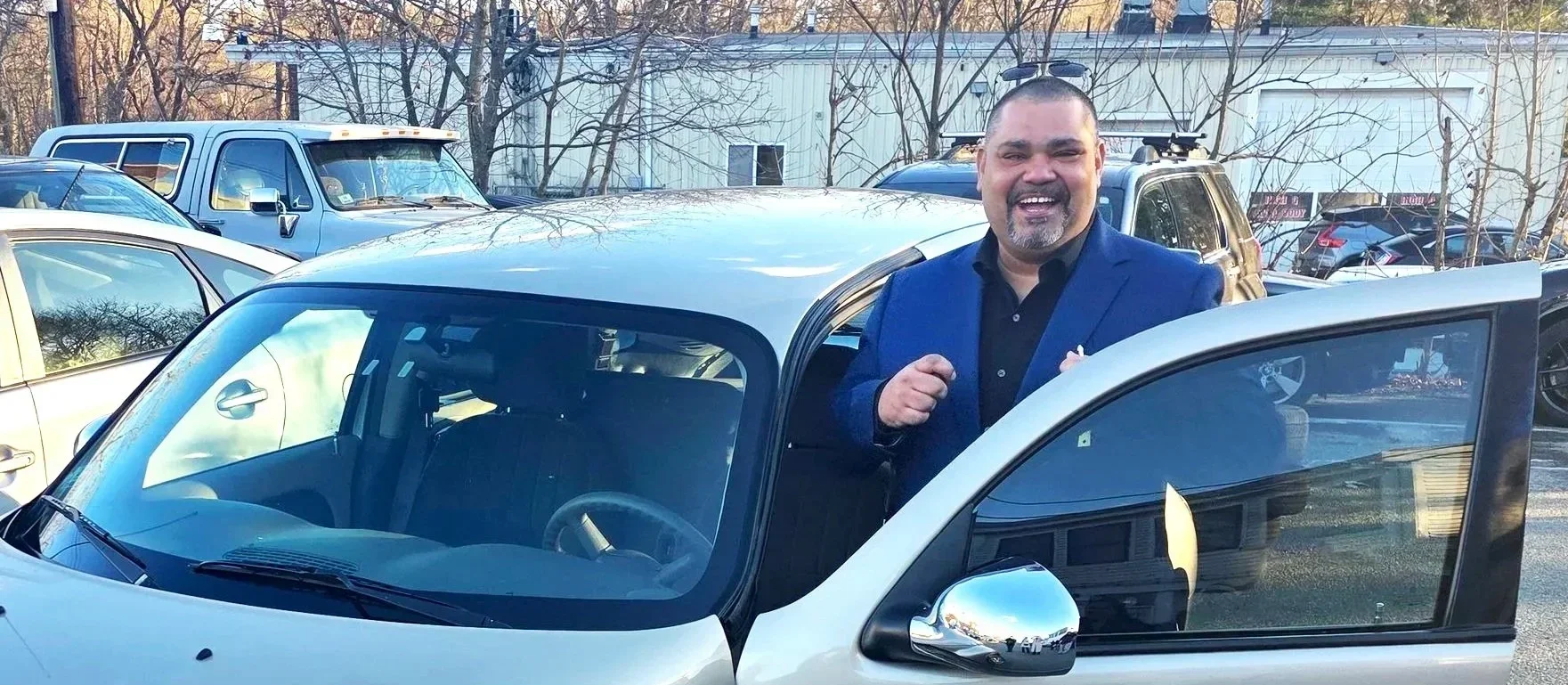 Exoneree standing with car that got donated by Second Chance Cars