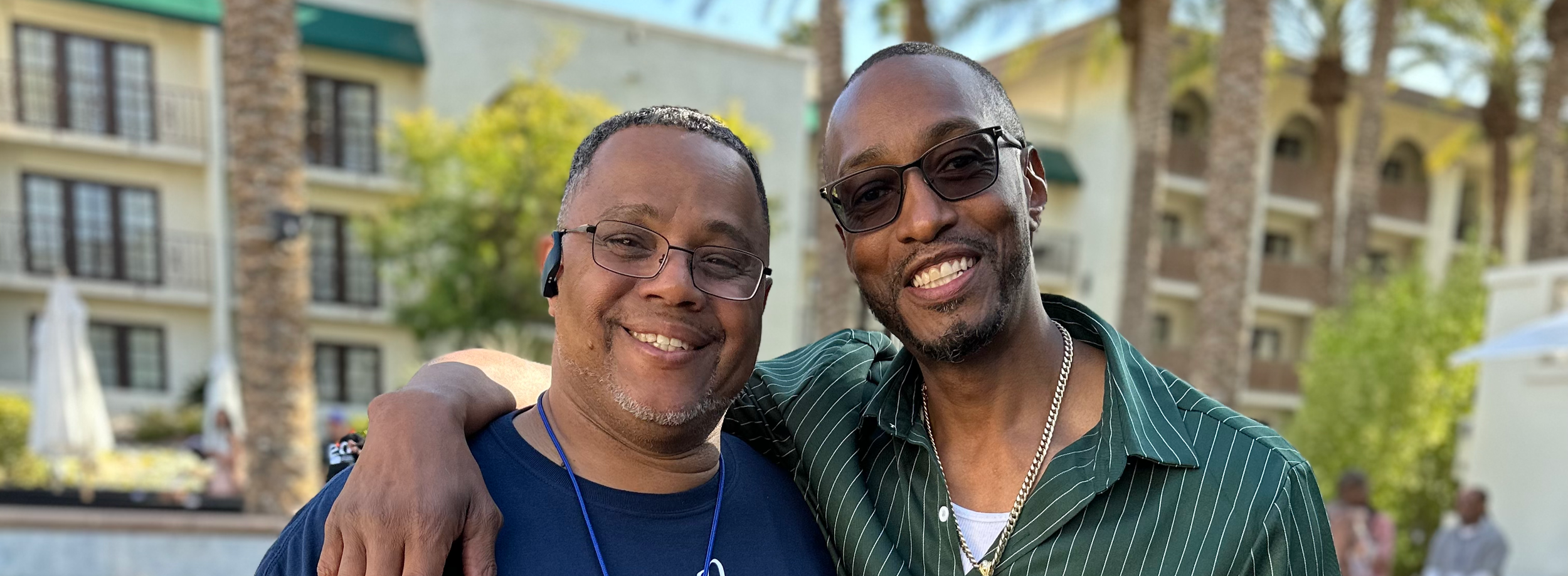 Two community members smiling