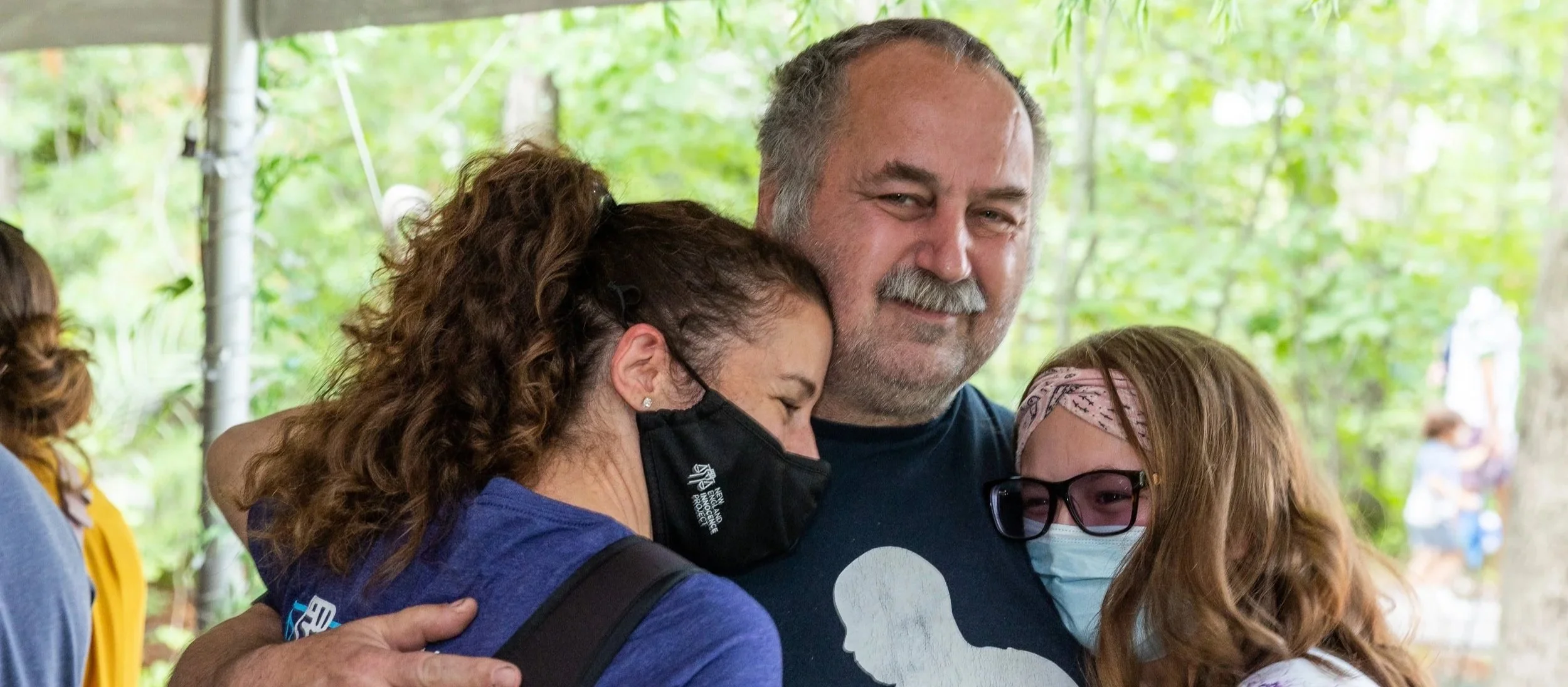 Dennis Maher hugging NEIP staff