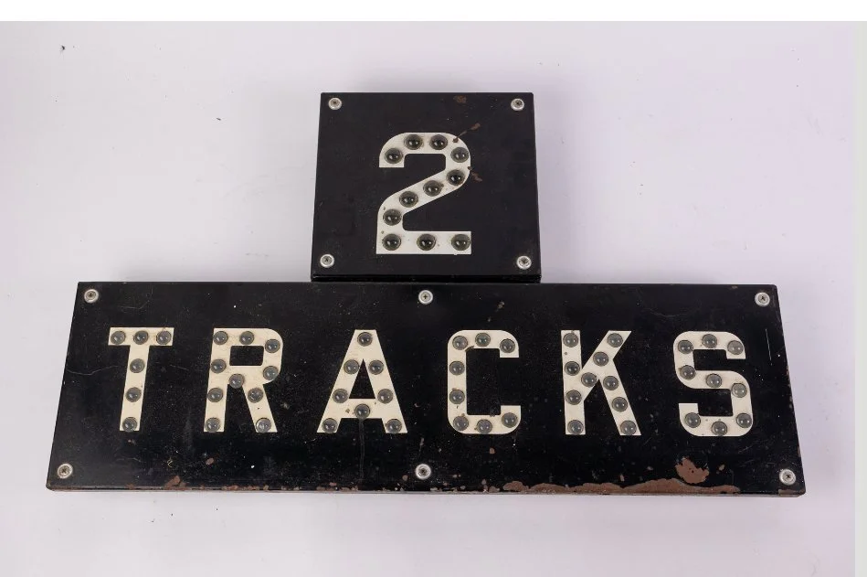 A black early Railroad crossing sign with white glass beads to illuminate "2 TRACKS".  Early Sign  great condition. 
