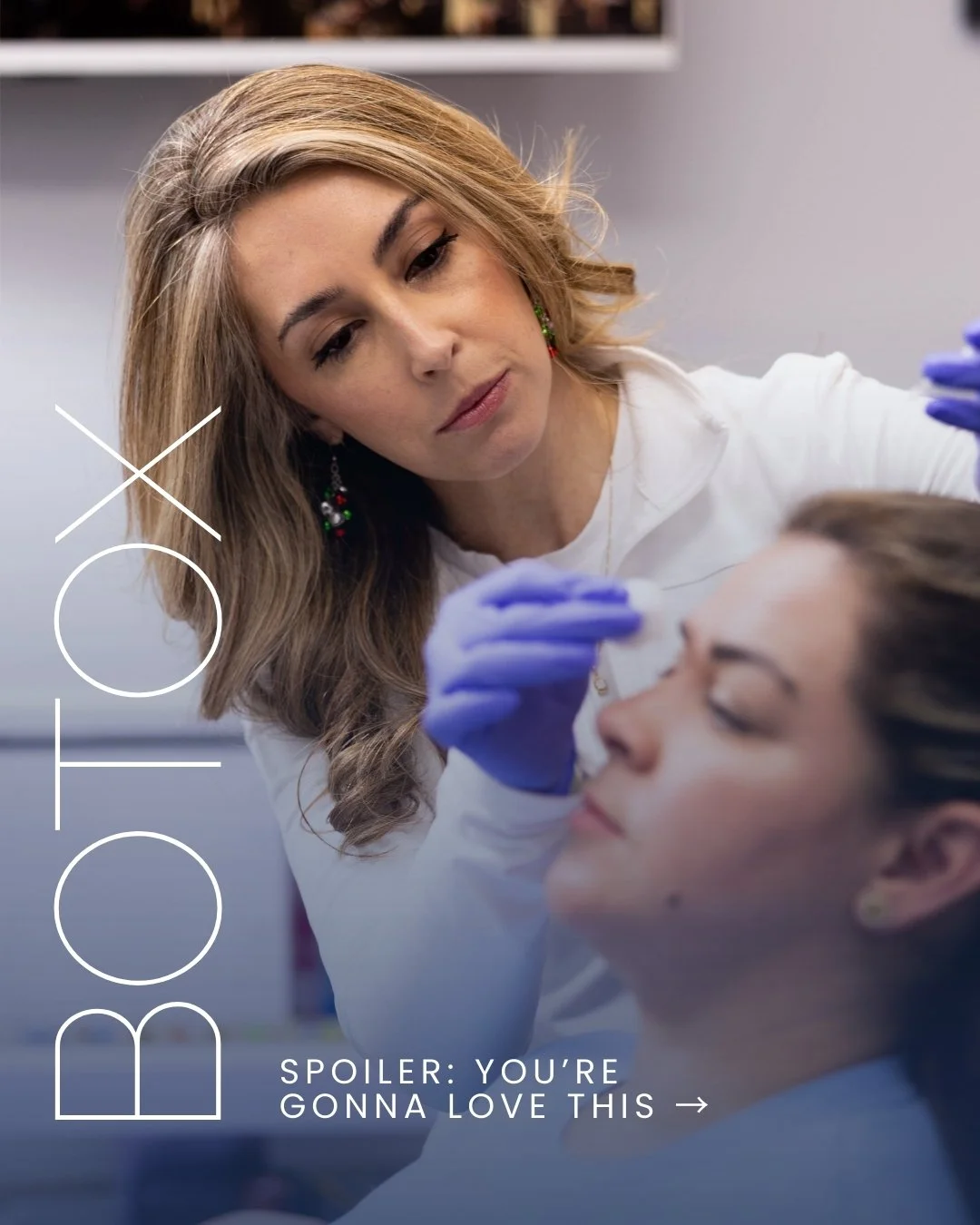 A woman with blonde hair and earrings applies makeup or performs a medical procedure on a younger woman with glassy eyes in a clinical setting.