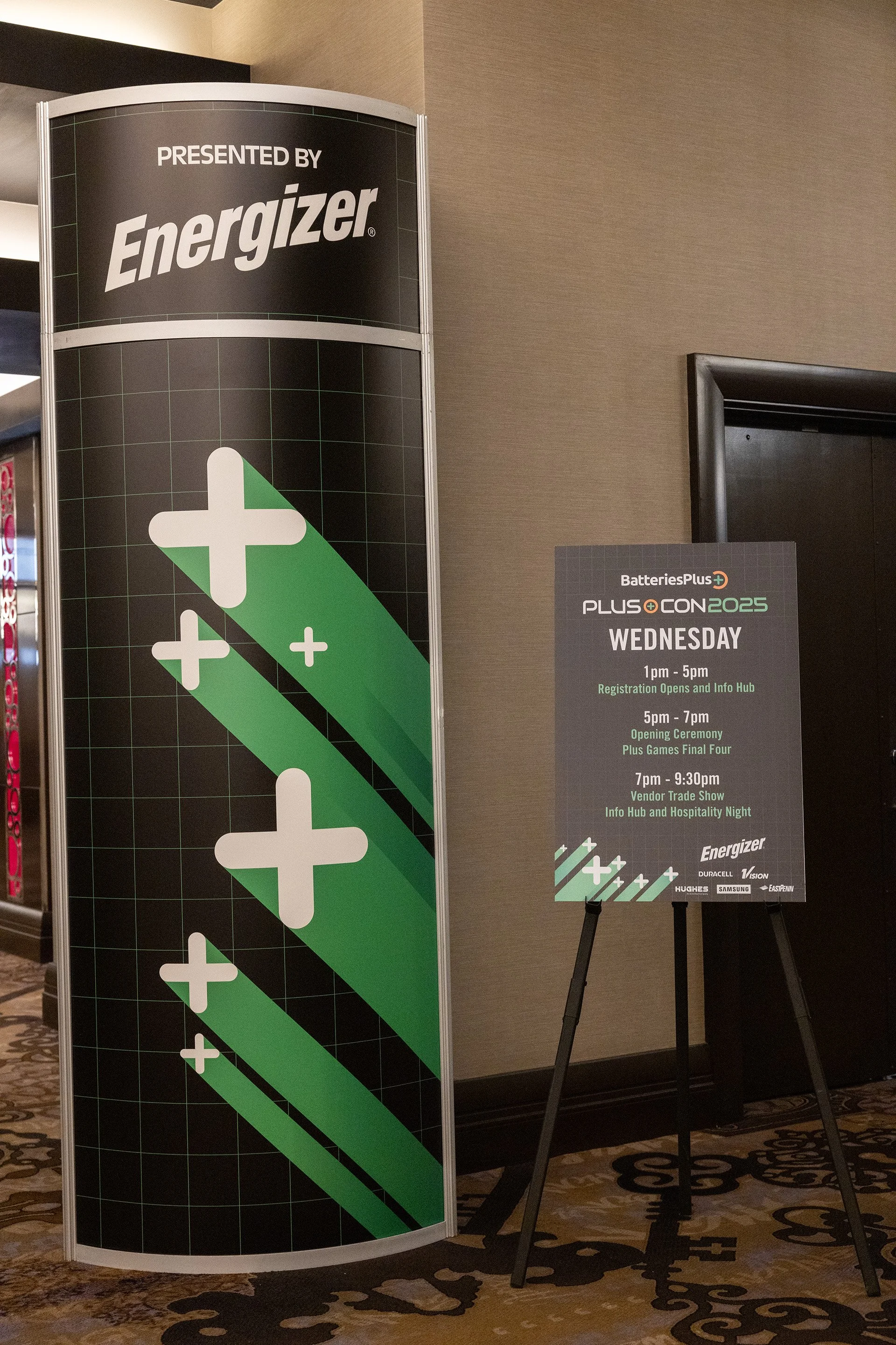 Signage and schedule for BatteriesPlus and Energizer event on Wednesday, including registration from 1pm-5pm, opening ceremony from 5pm-7pm, and vendor trade show from 7pm-9:30pm, with logos of Energizer and sponsors at the bottom.