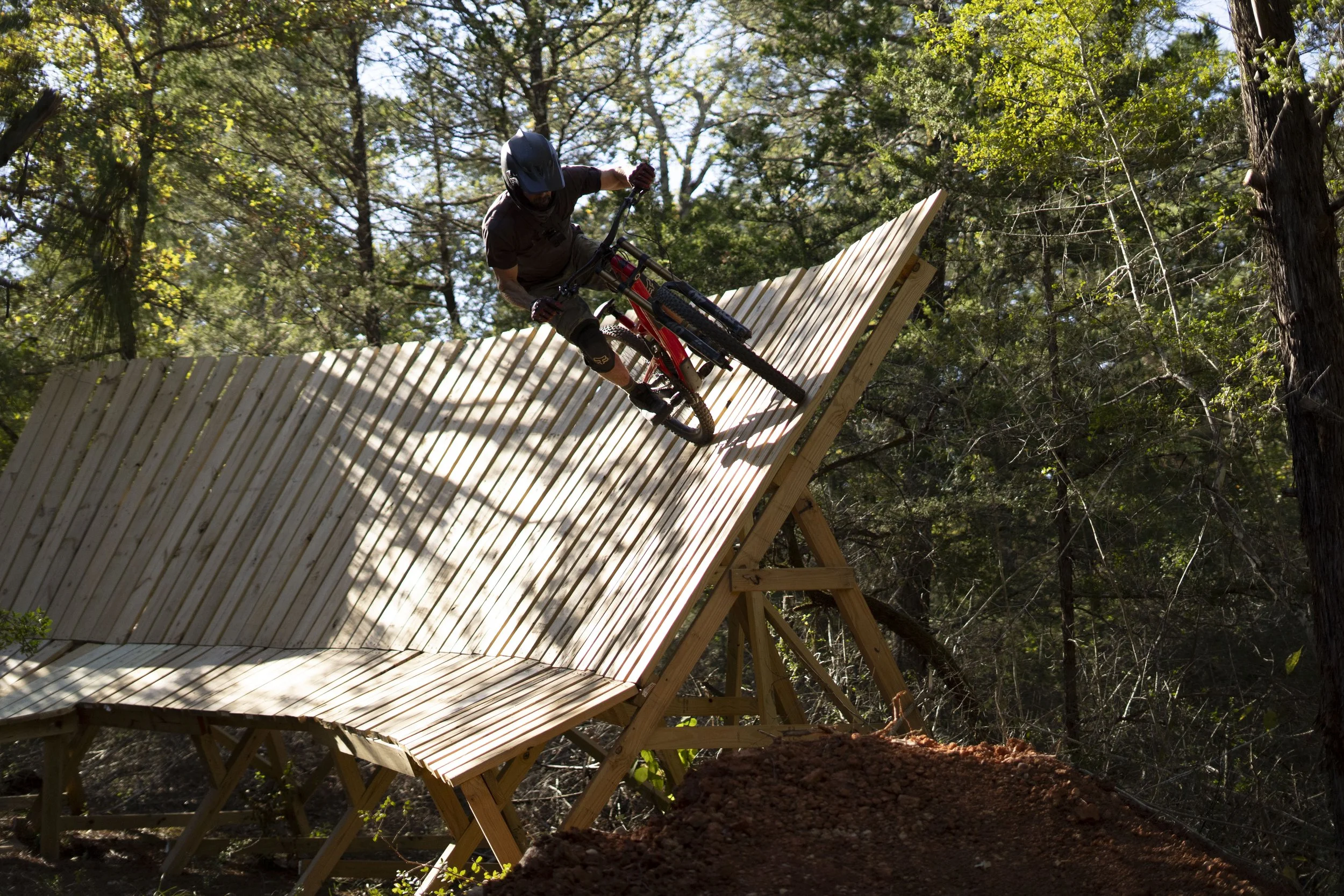 Rider hitting the Wallride Feature at the Freeride512 bike park."