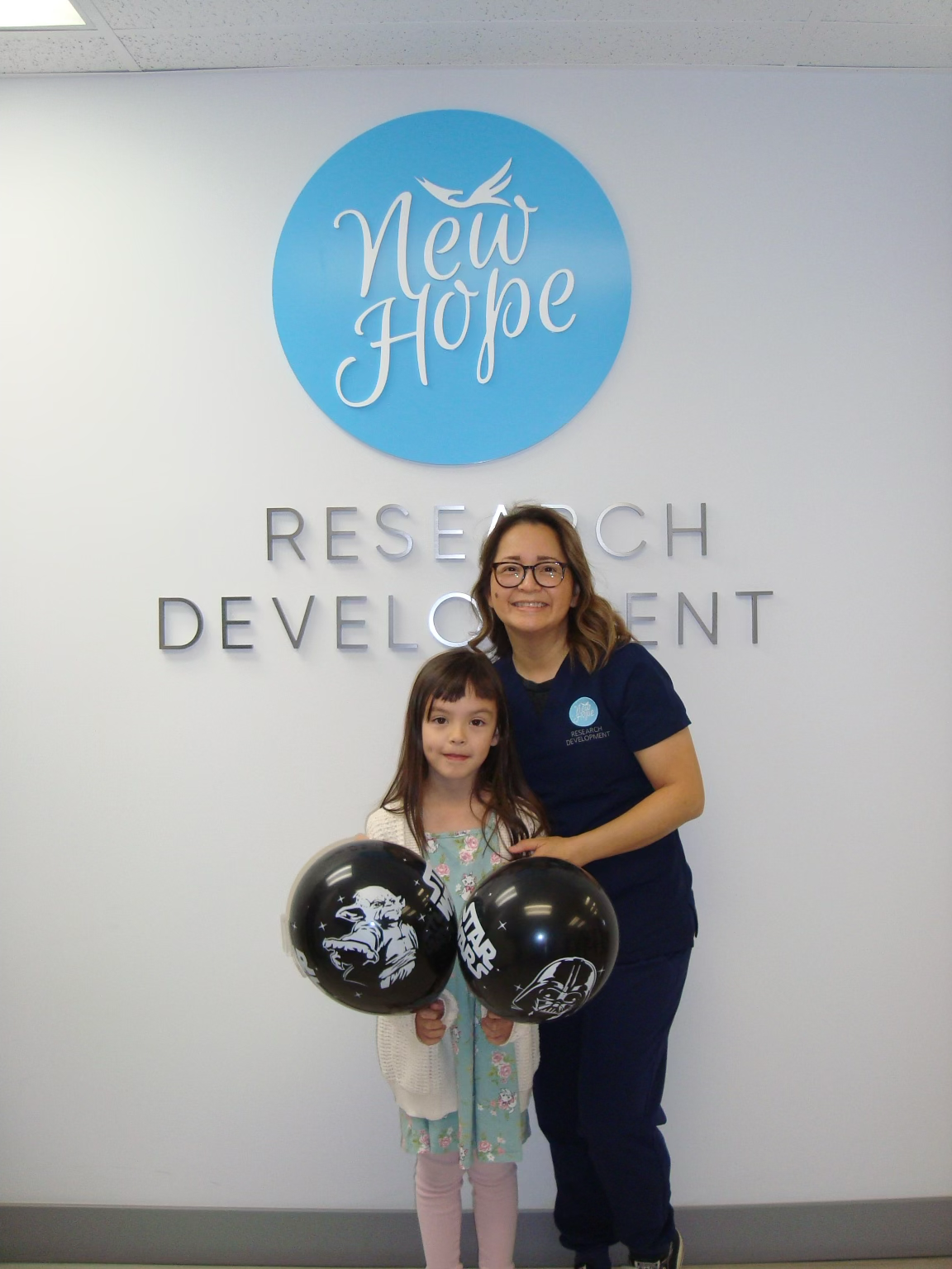 staff member with kid smiling at camera