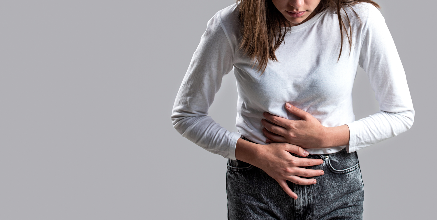 woman holding stomach in pain