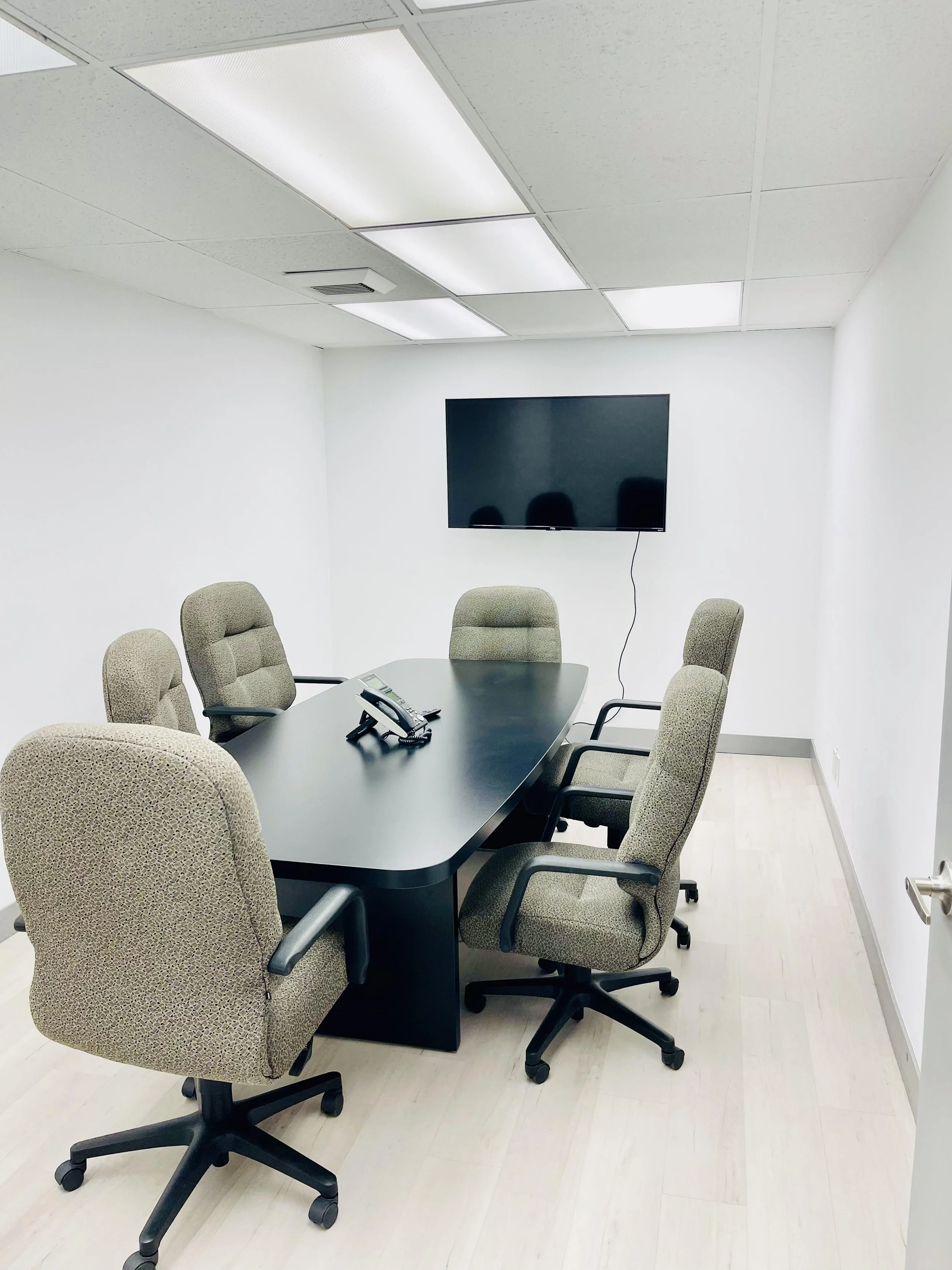 conference room with chairs table and tv