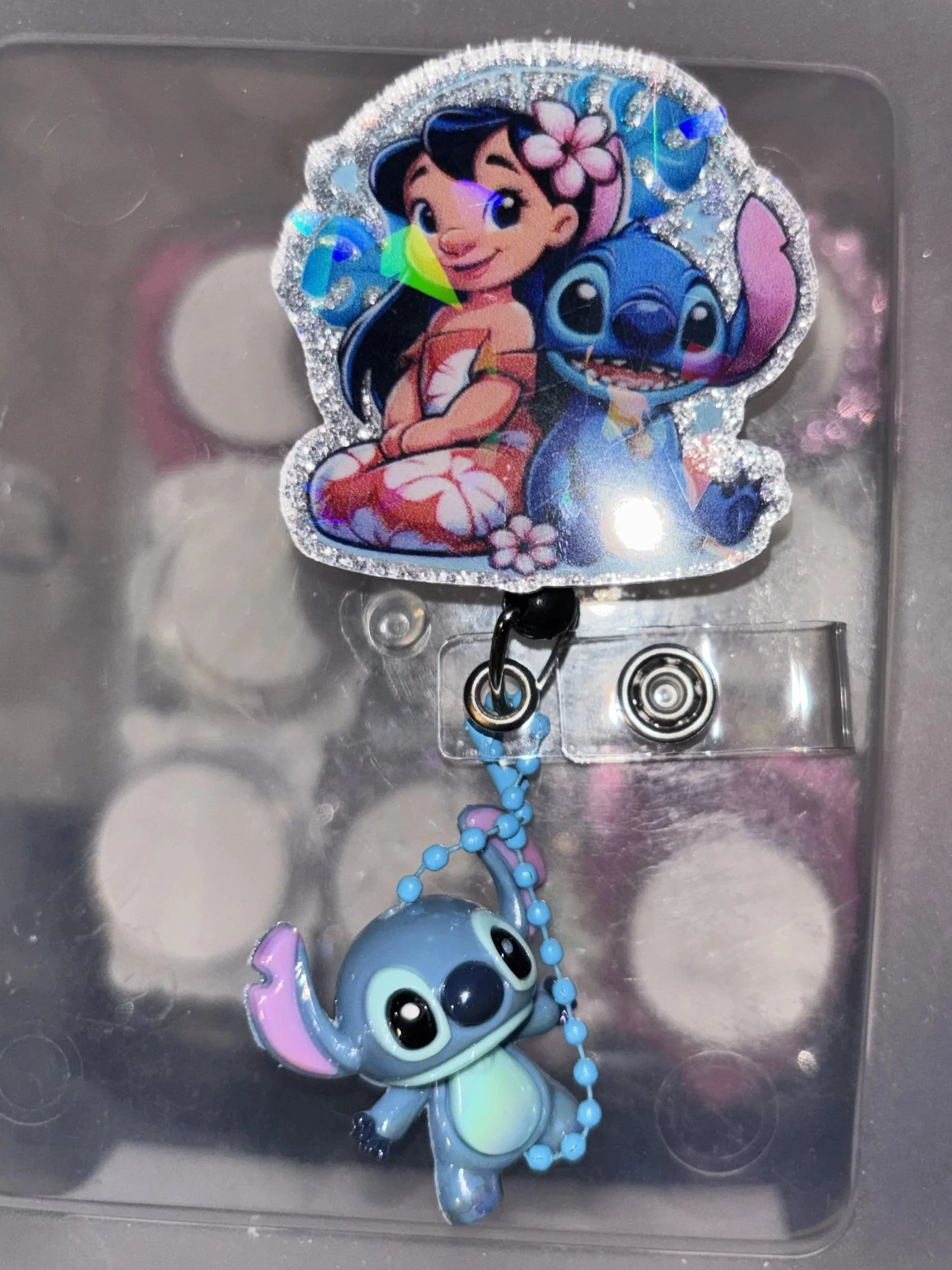 Stitch & Lio sitting back to back badge reel with 3D Stitch keychain