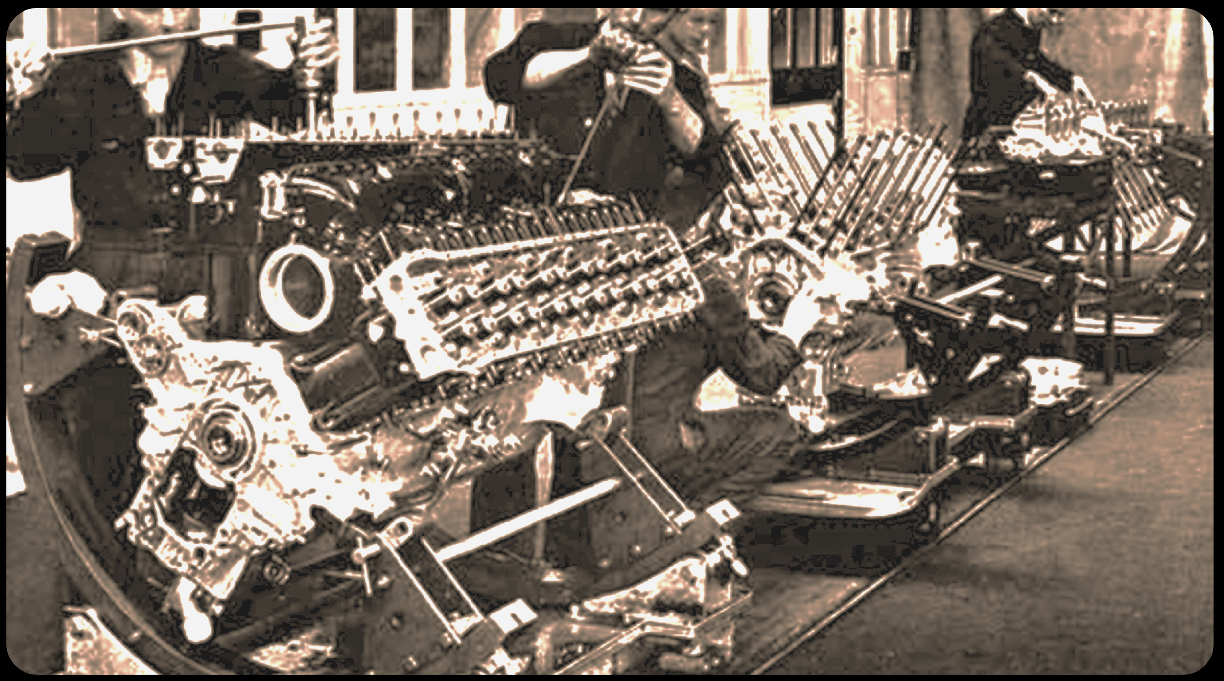 Black and white image of an engine display, with various parts, gears, and mechanical components visible. There are people working on or inspecting the engine in the background.