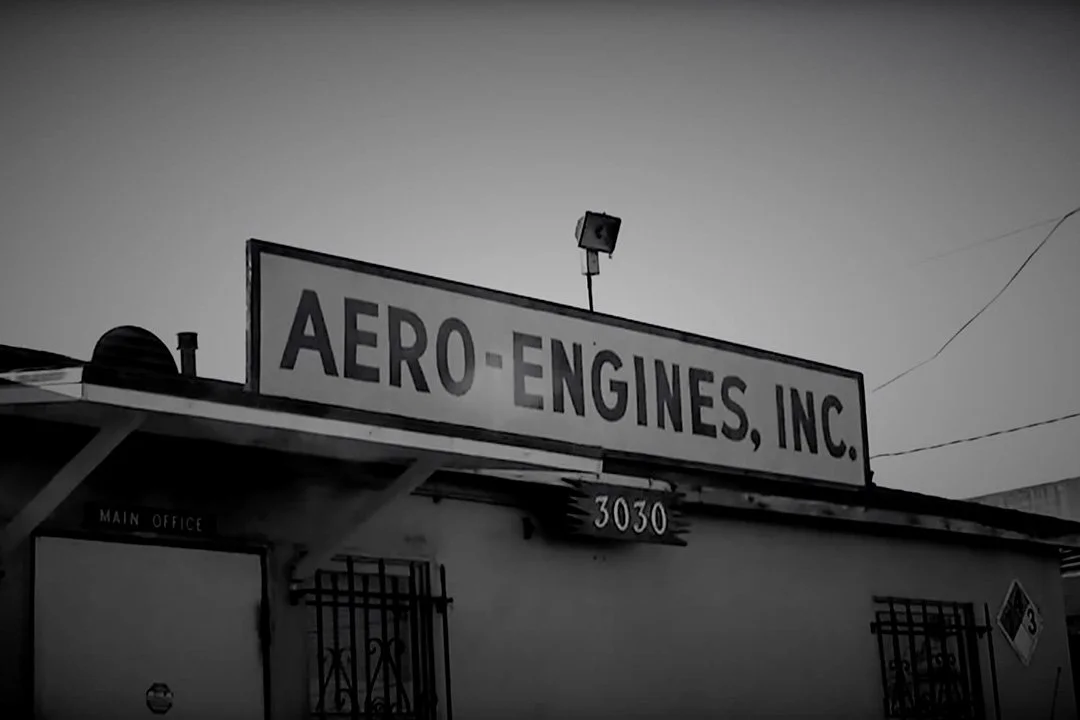 Sign on building reading 'Aero-Engines, Inc.' with address 3030 below.