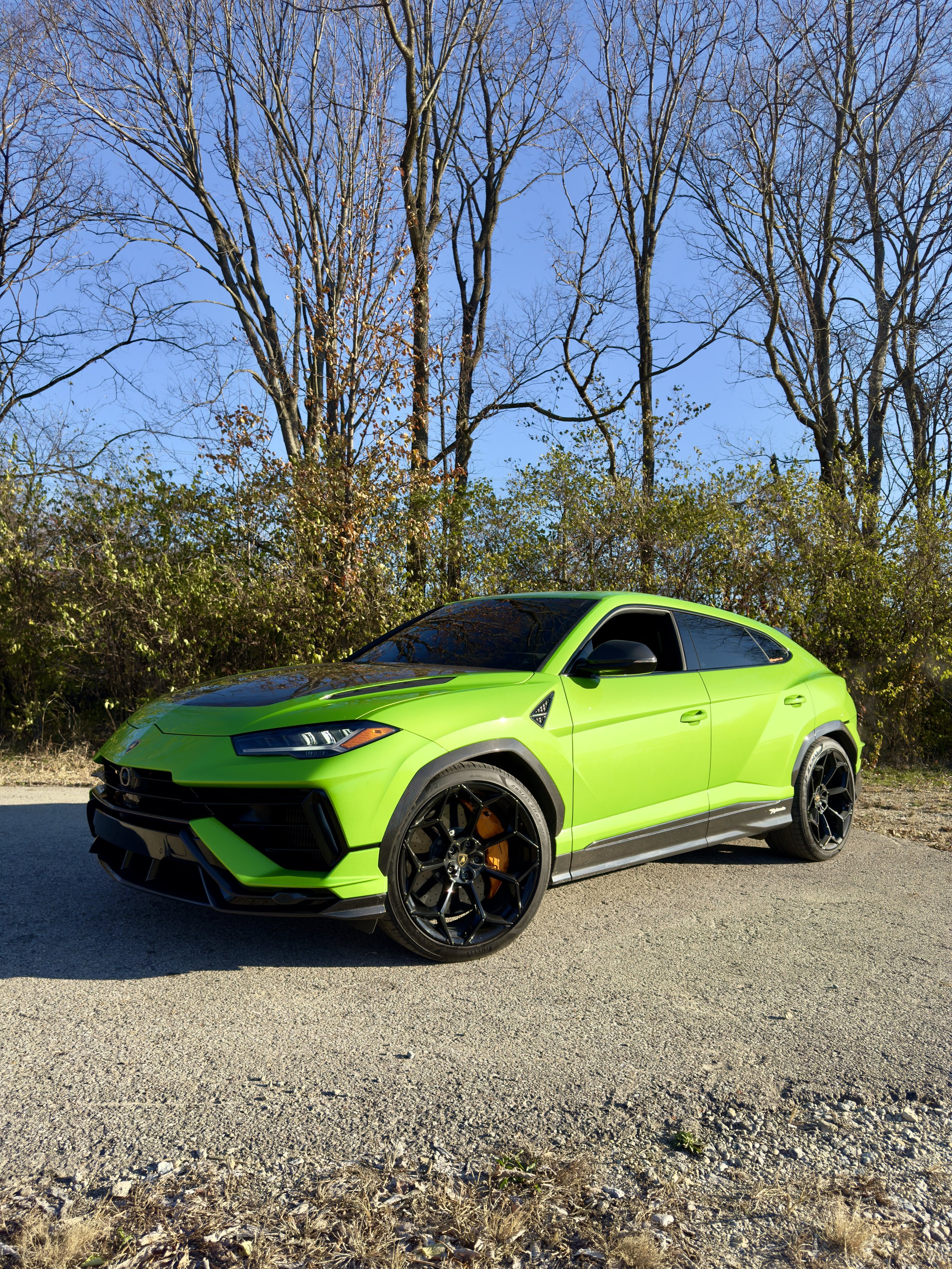 Paint protected Lamborghini Urus under a clear blue sky.