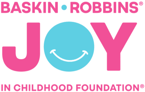 Logo for Baskin Robbins' Joy in Childhood Foundation, featuring pink and blue text and a smiling blue circle with a white smile.