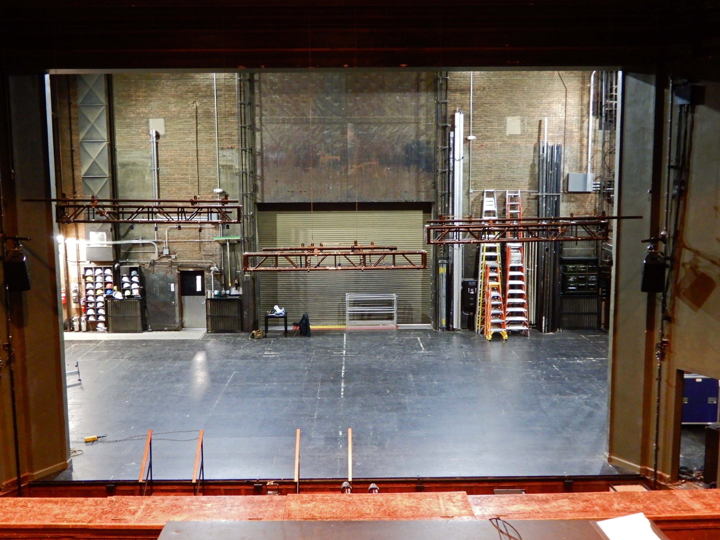 Open stage during work call, with rigging in and tools on stage.