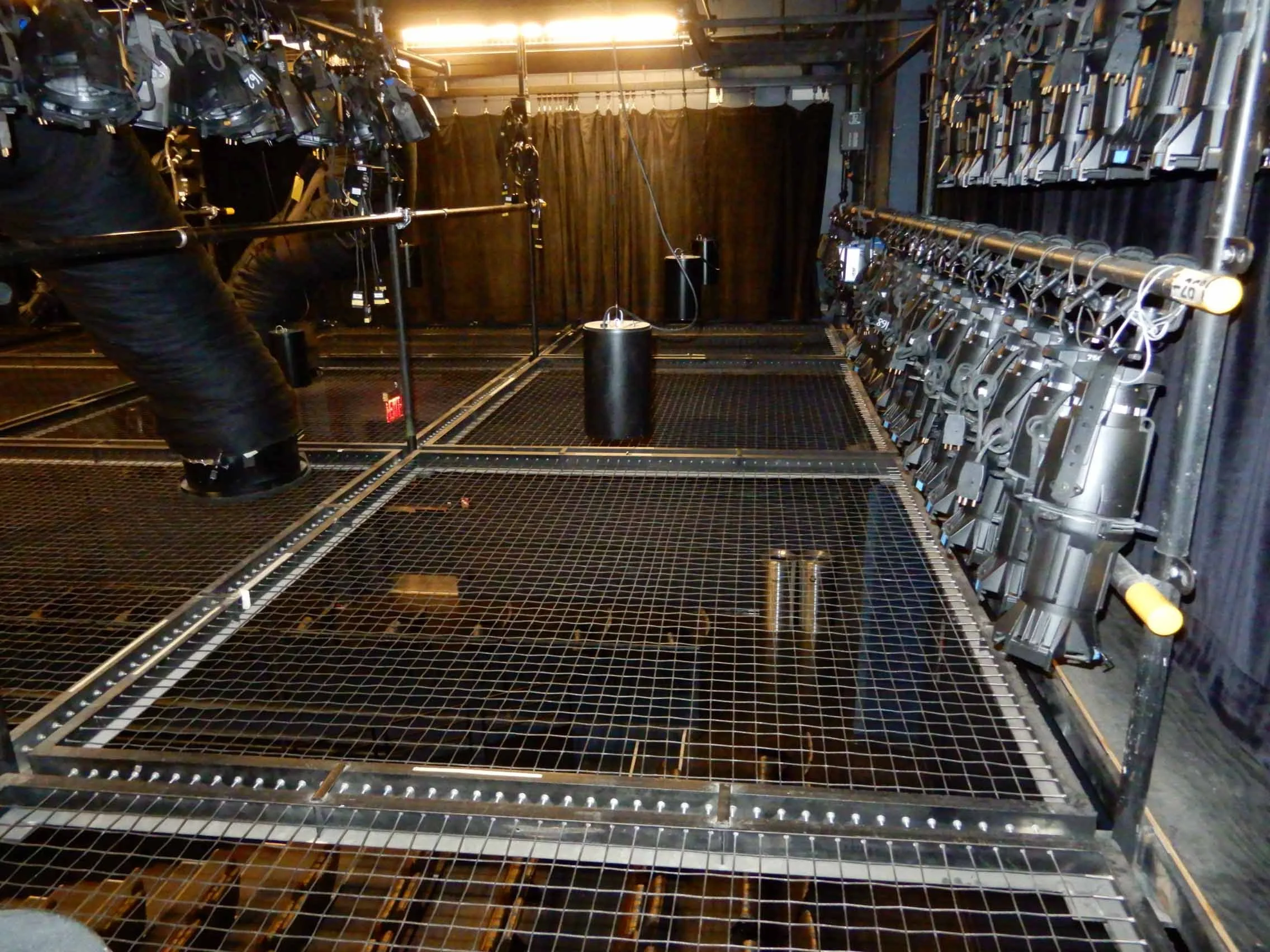Tension wire grid showing lighting storage above the stage.