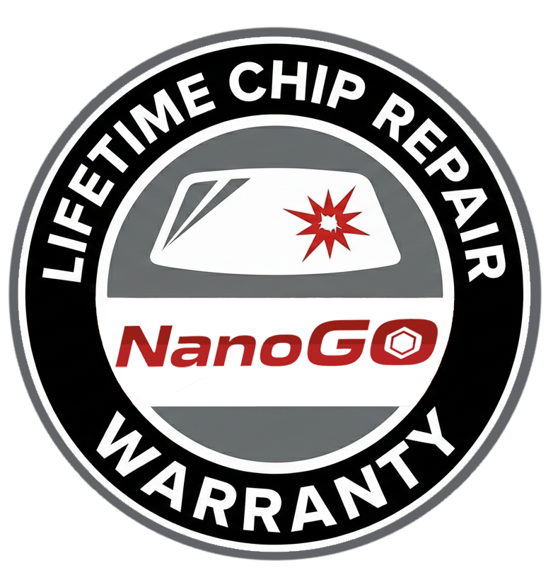 A circular badge with a black outer ring and white text that reads, "Lifetime Chip Repair Warranty." Inside the circle, there is a graphic of a windshield with a red starburst indicating damage, and the logo "NanoGo" in red text beneath the windshield.
