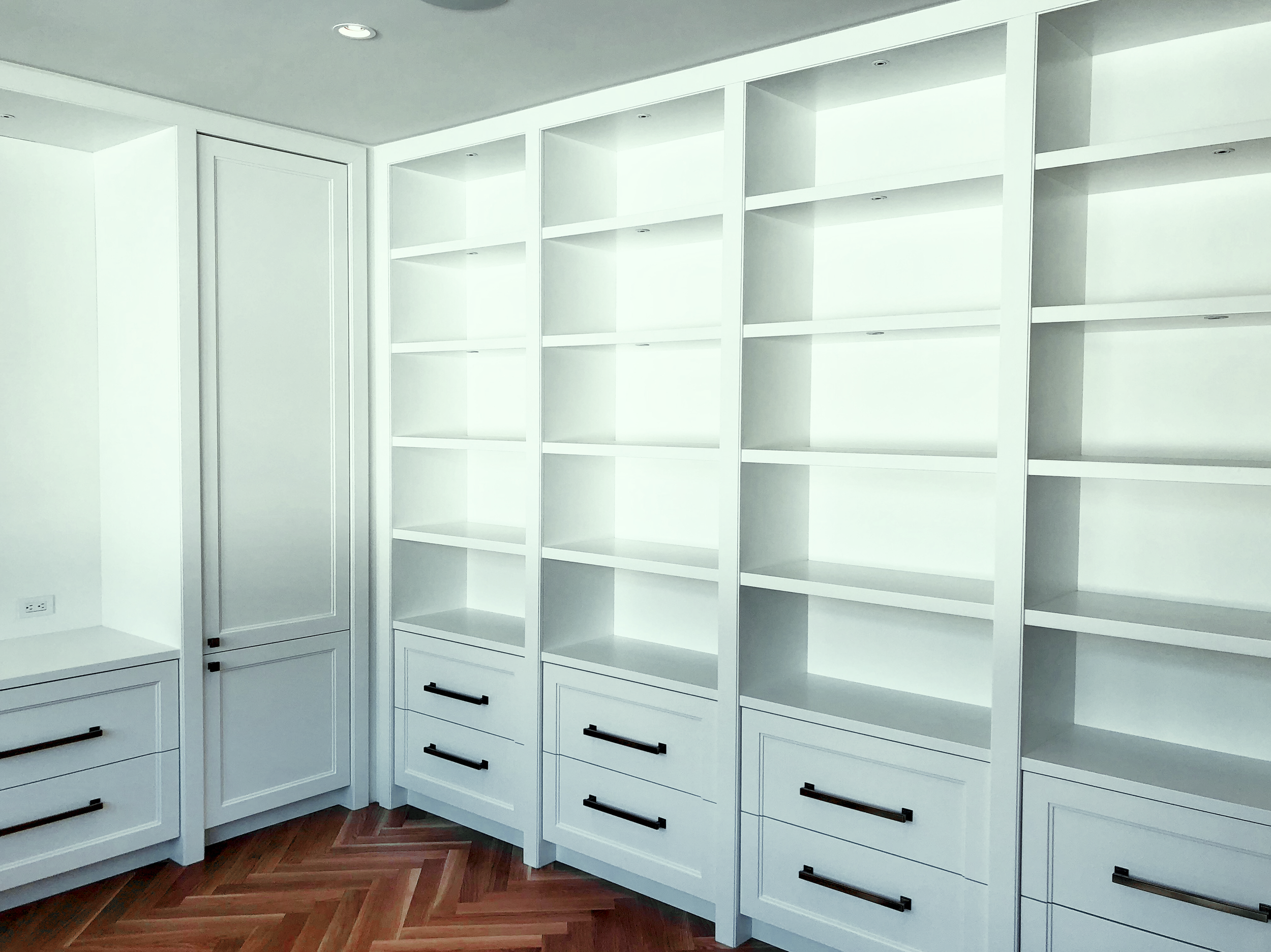 Prior fabrication experience.
White home office with open shelving, drawers, and integrated storage.
