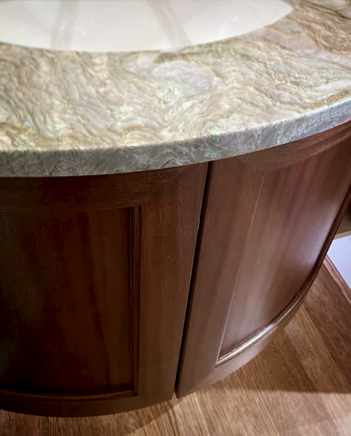 Prior fabrication experience.
Curved mahogany vanity with paneled doors.