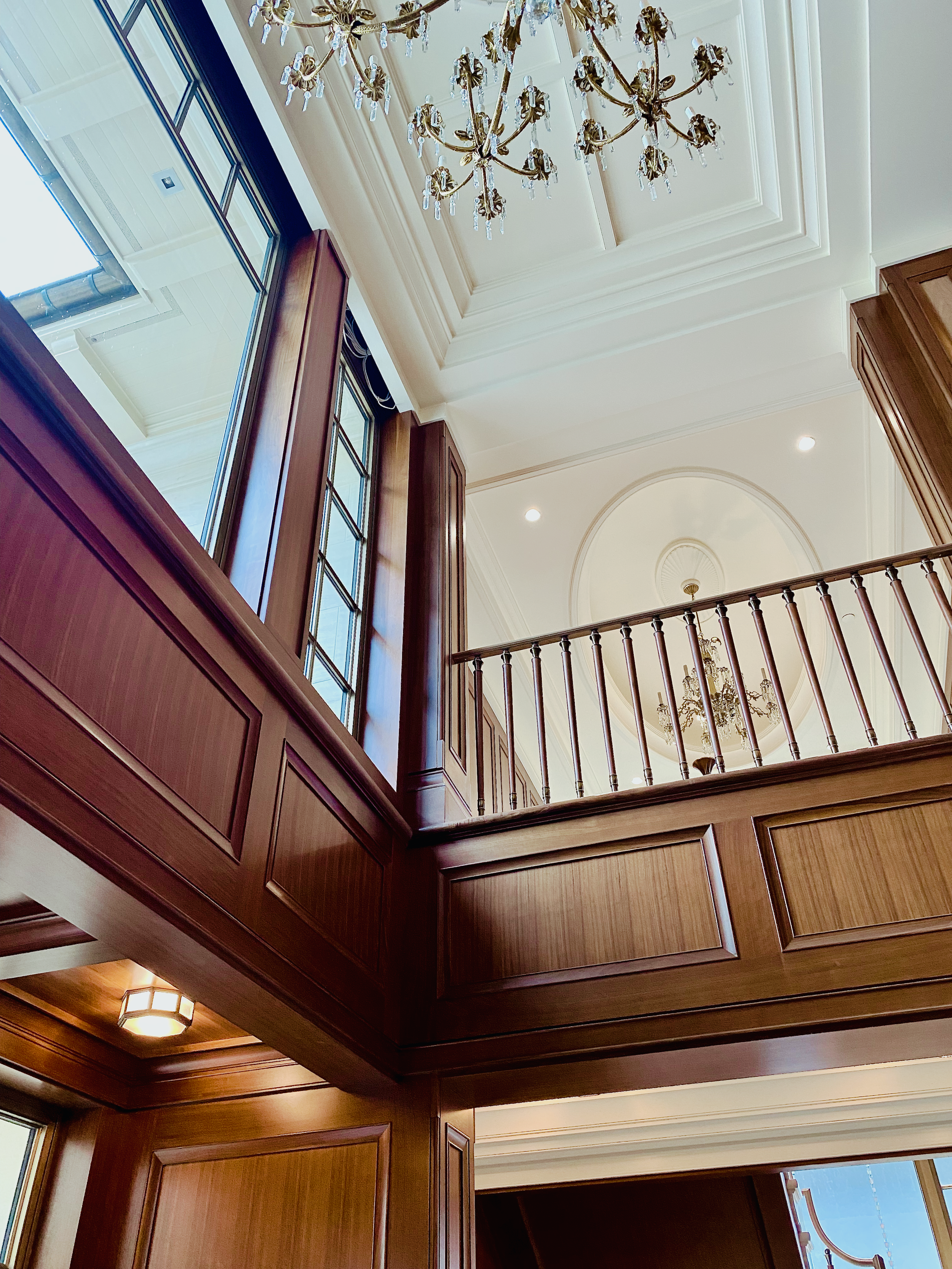 Prior fabrication experience.
Walnut wall panels with raised detailing in a double-height interior.