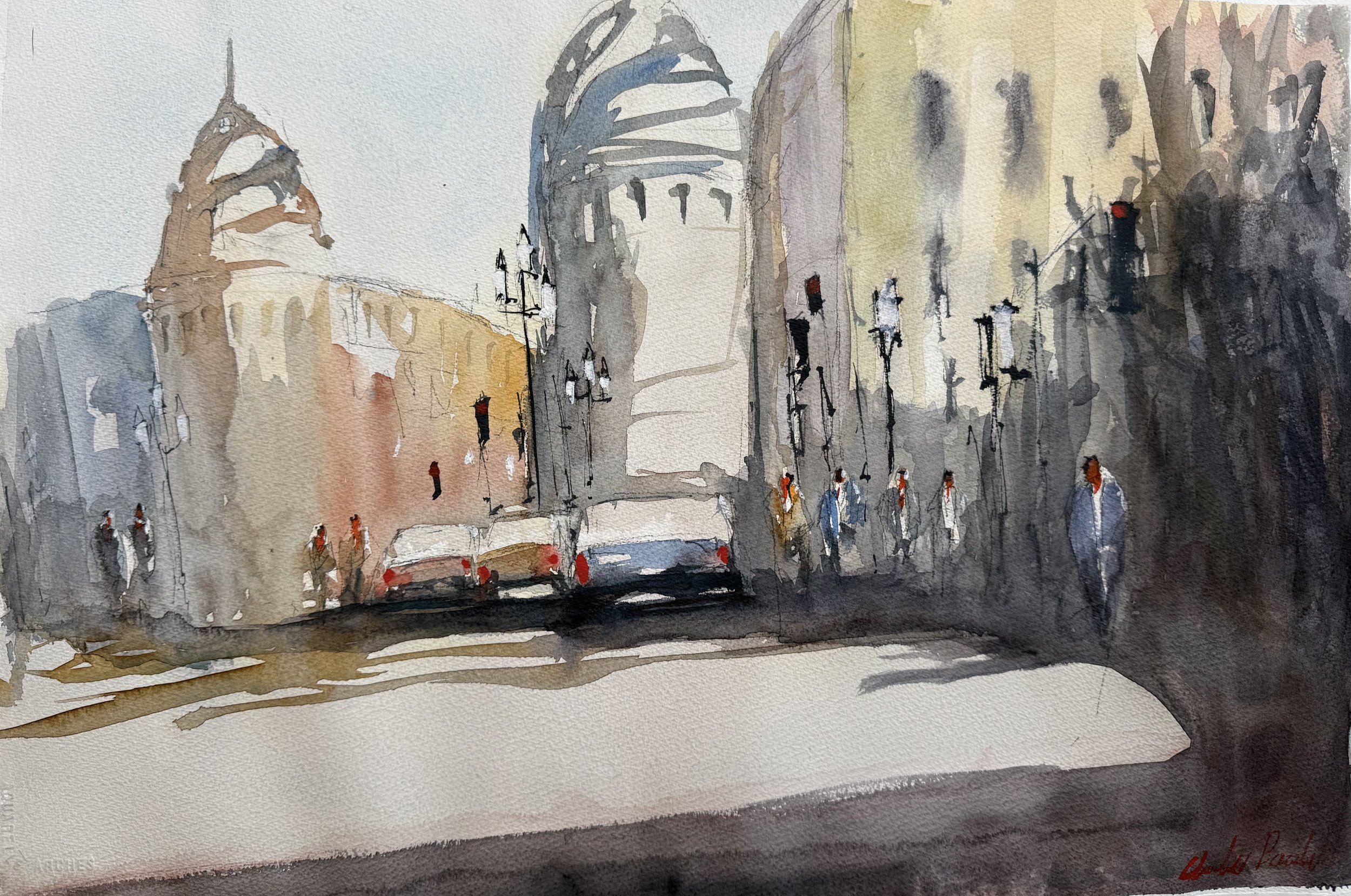 Watercolor painting of a city street scene with tall buildings, street lamps, parked cars, and pedestrians on the sidewalk, with a church or clock tower in the background.