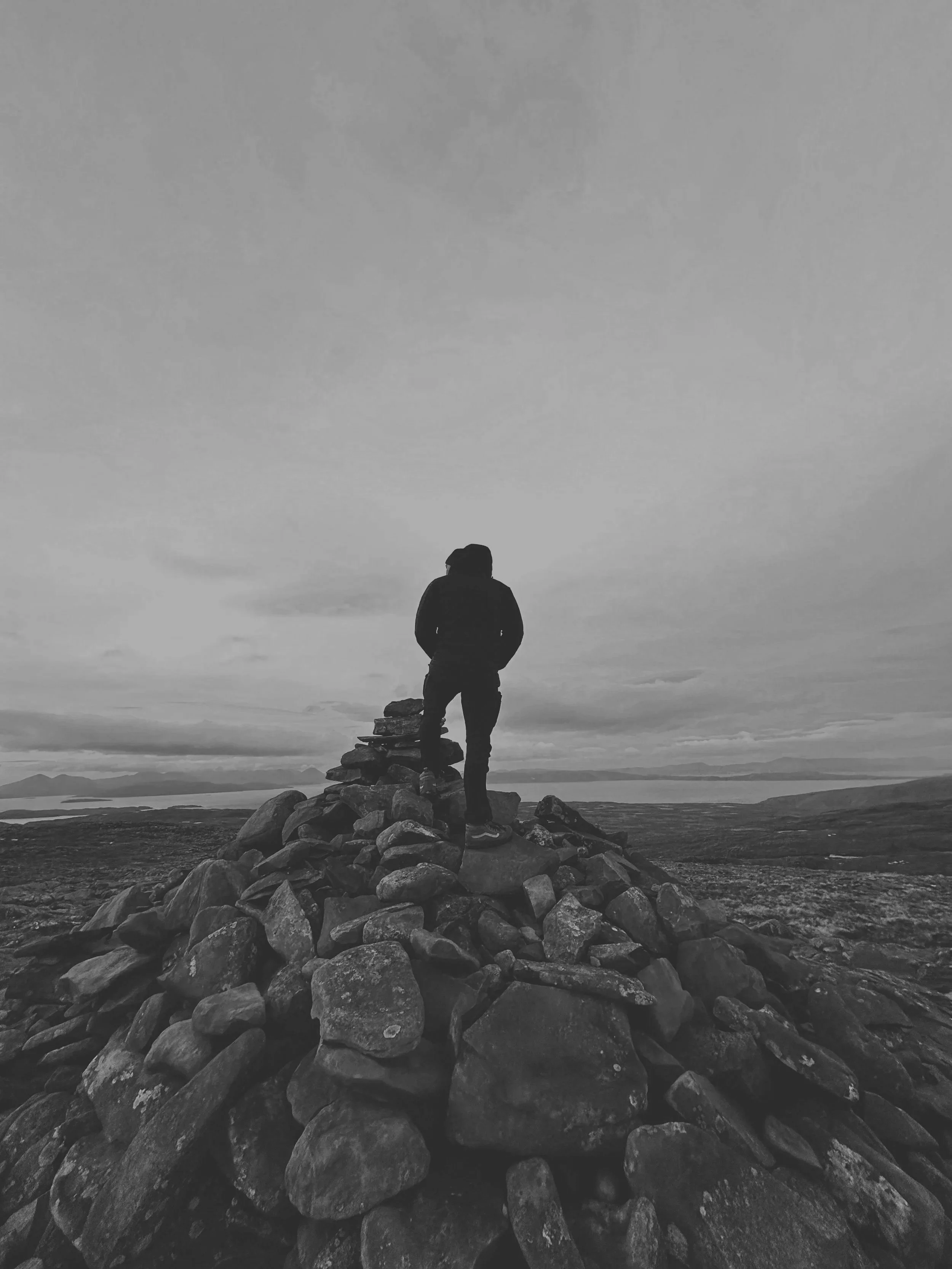 Man on hilltop looking at the view.