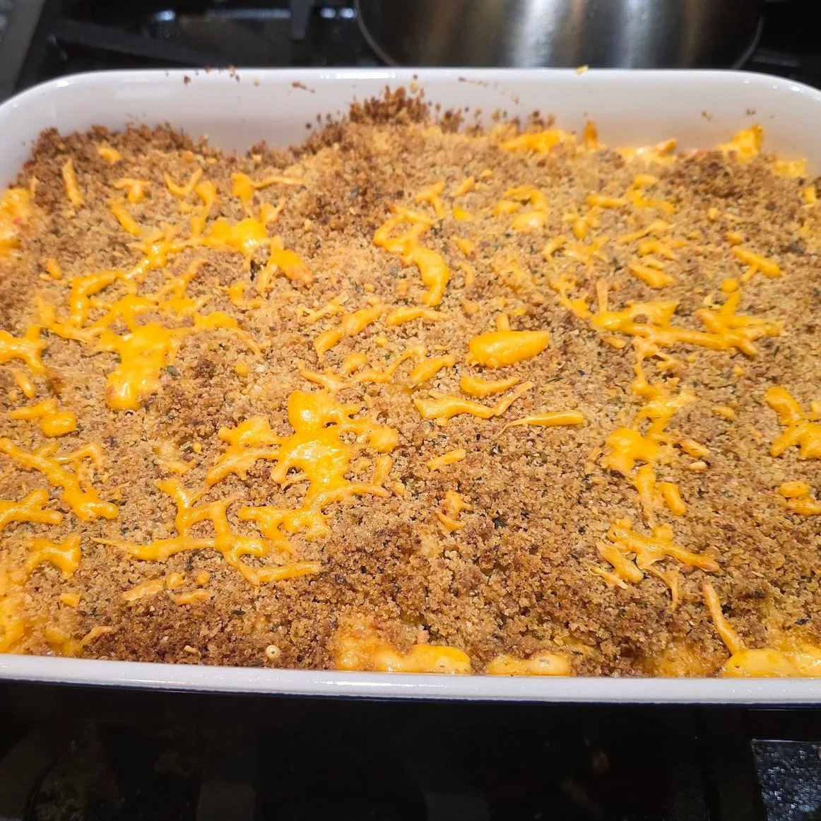 Check out this cheesy mac and chicken bake we made for Sunday supper last weekend. Not seen: Pimento and sharp cheddar cheese. Making this extra spicy and tasty. Also not seen: The baked and then fried chicken we put on top. Message for how it came t