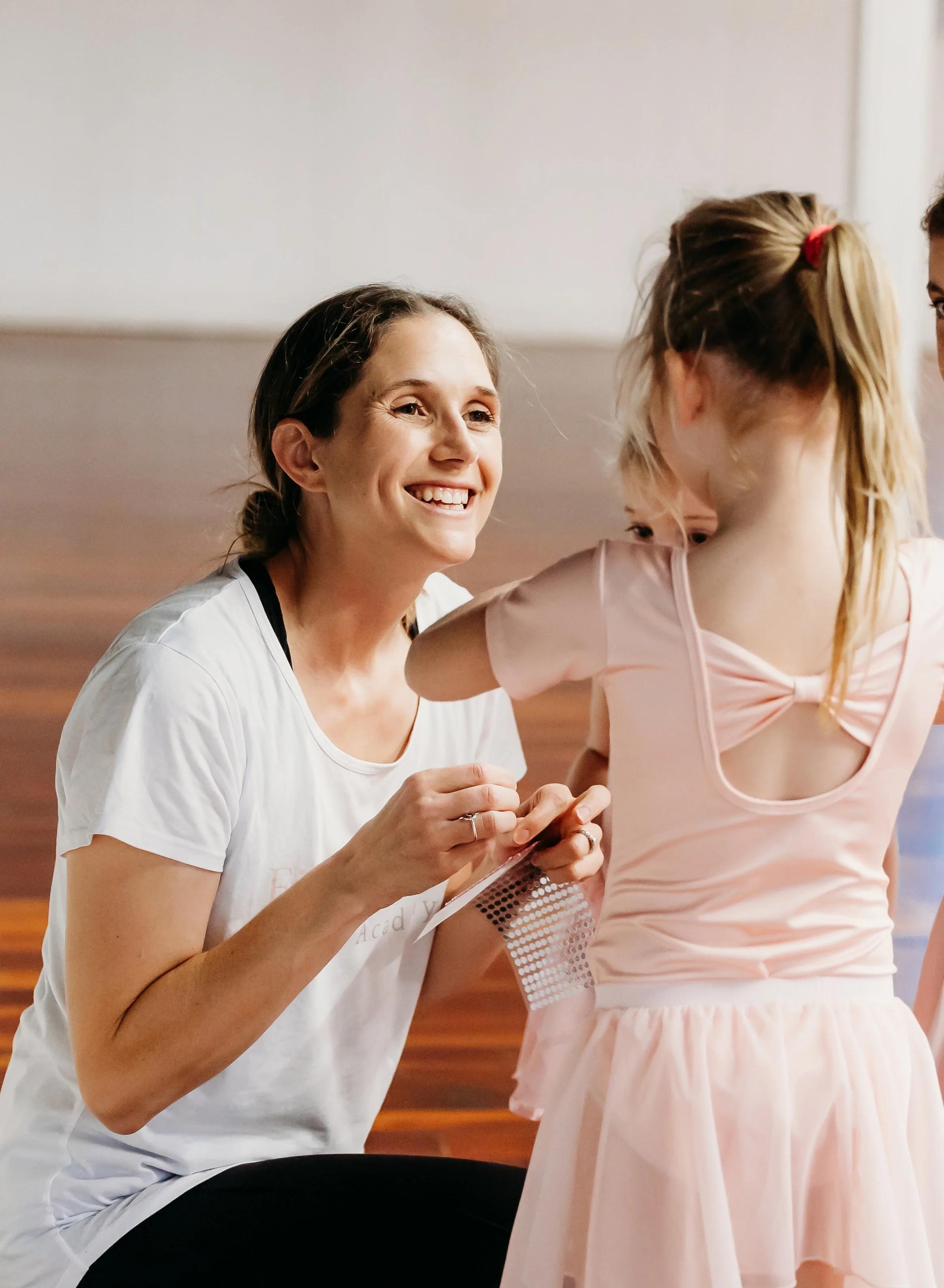 Jess giving out stickers to dancers at the end of class